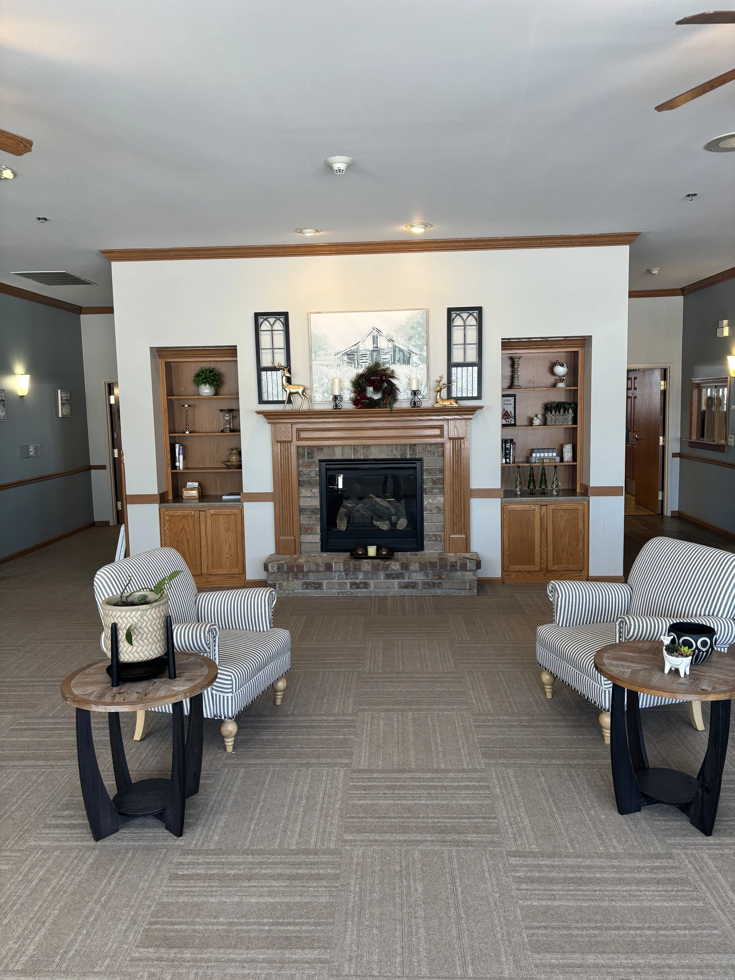Front day room with seating and fireplace at Havenfield.