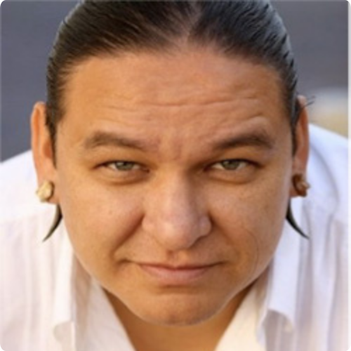 Dalin Maybee, Commissioner, close-up portrait smiling slightly at the camera.