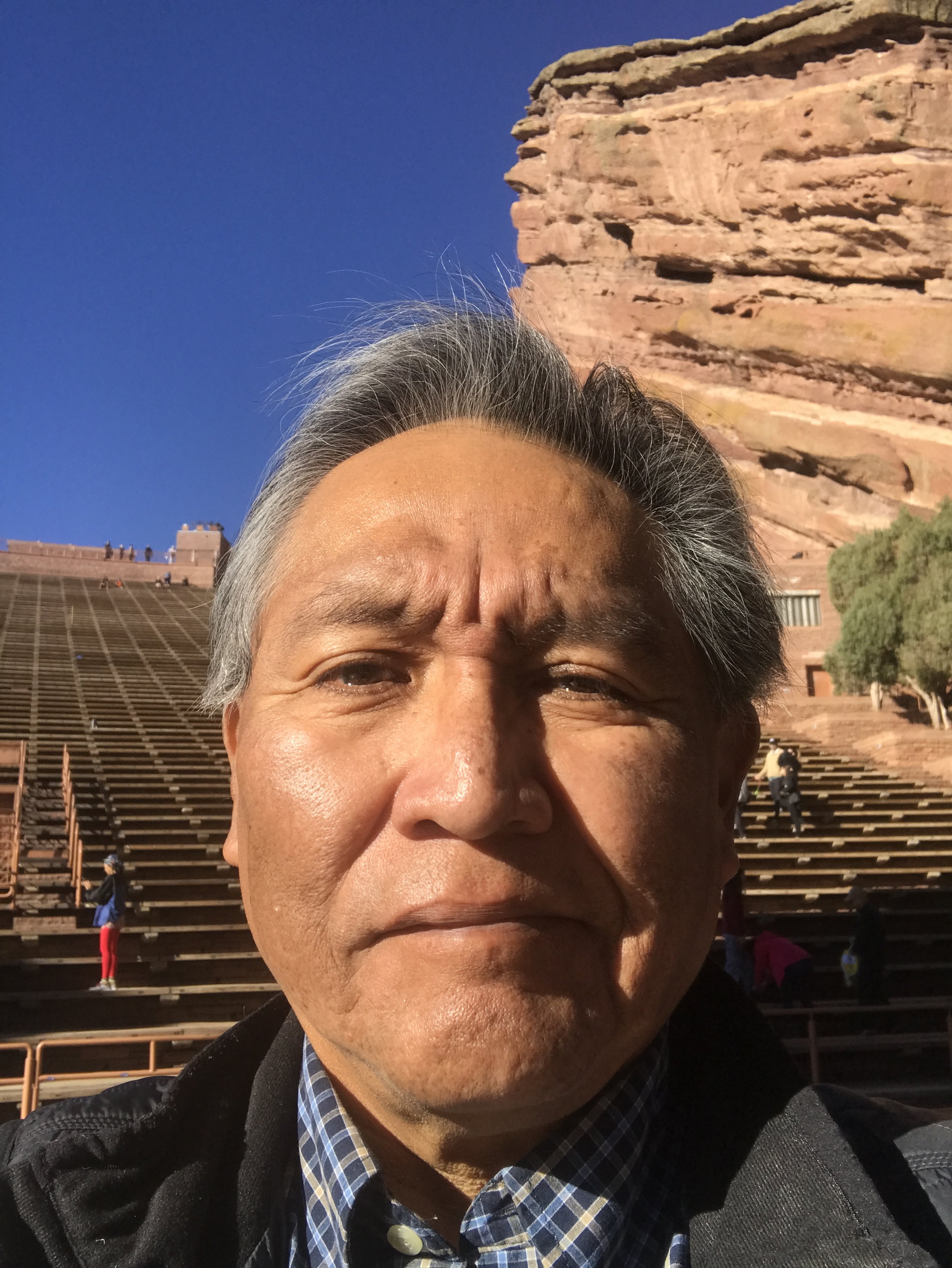 Director Donald Whyte smiling for a photo with red rocks in the background.