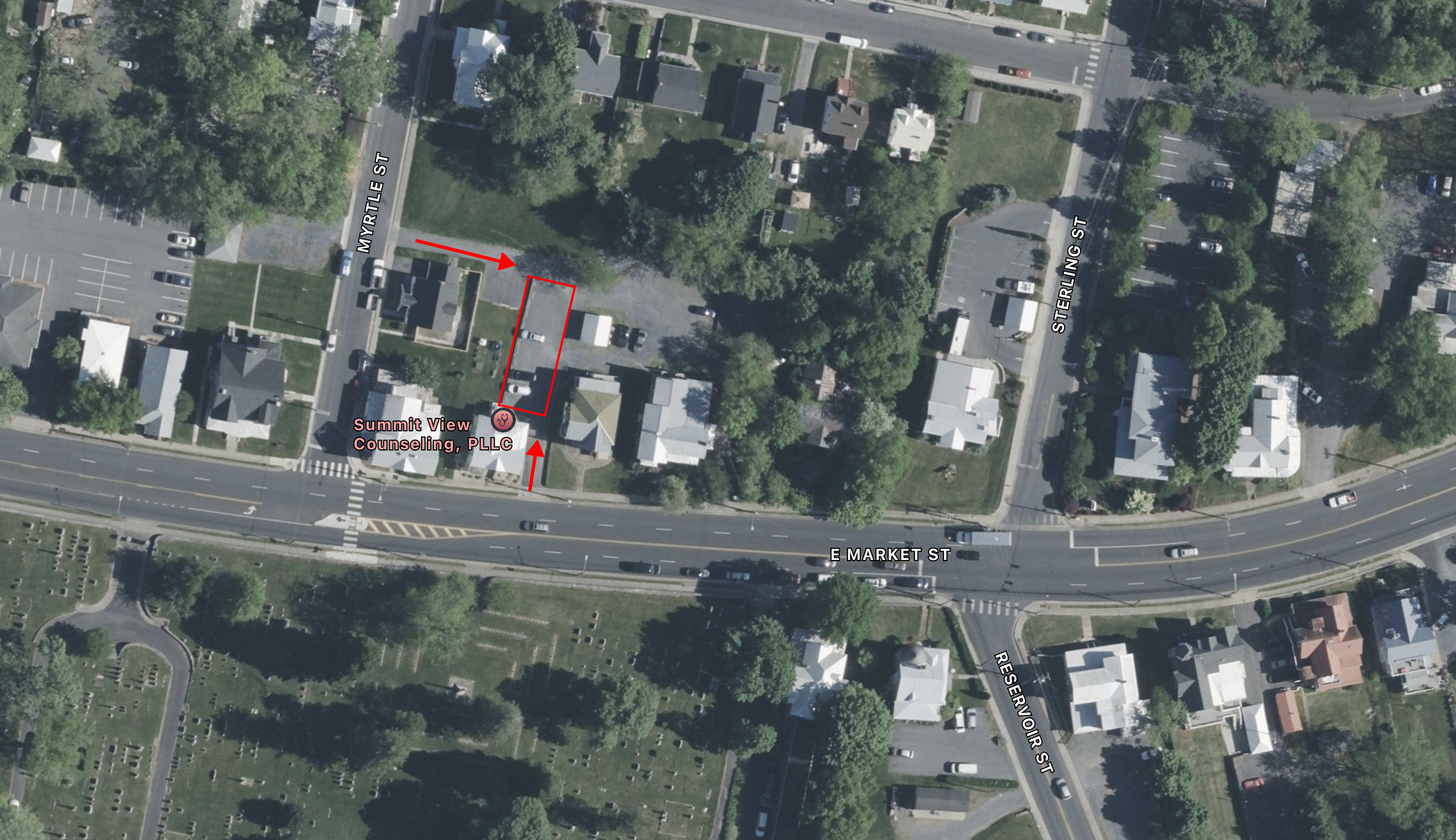Aerial view of the Harrisonburg, VA location for Summit View Counseling. A rectangular area is marked in red with arrows pointing to it, indicating parking, near the intersection of Myrtle Street and E Market Street.