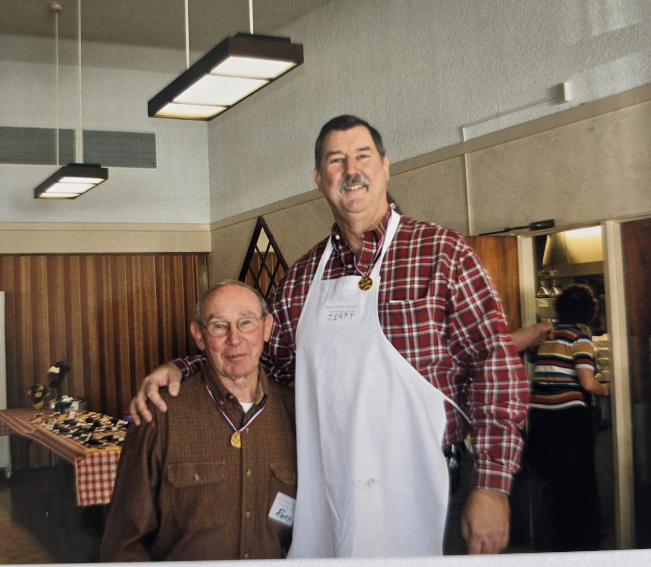 two volunteers working bbq