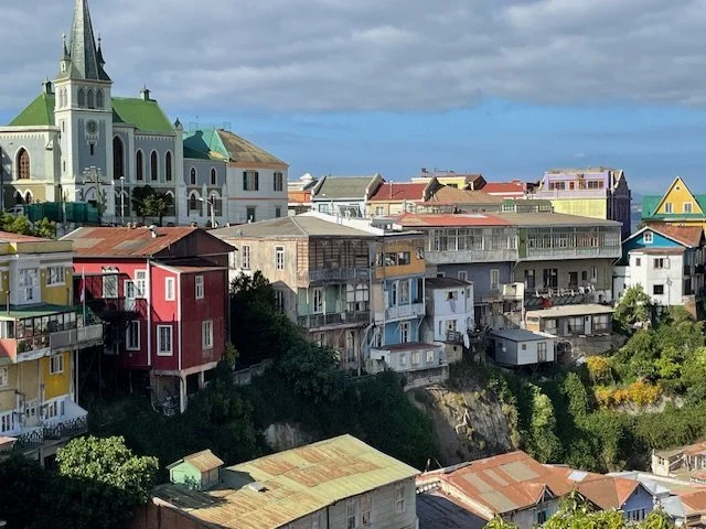 Colorful houses and a church on a hillside in Chile, part of a small group wine country tour with Chilean Wine Uncovered and Popi Planella.