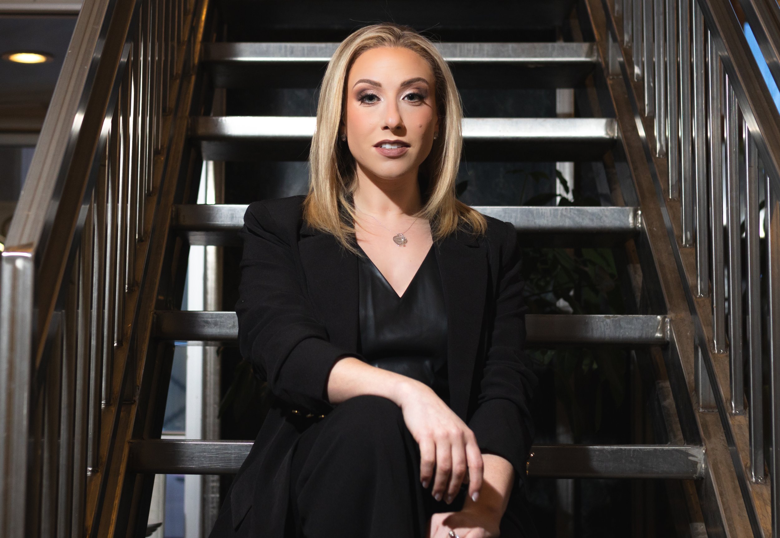 Alyssa Sacco at the bottom of the stairs in Joe Petrullo's coffee shop on Genesee St, Utica NY