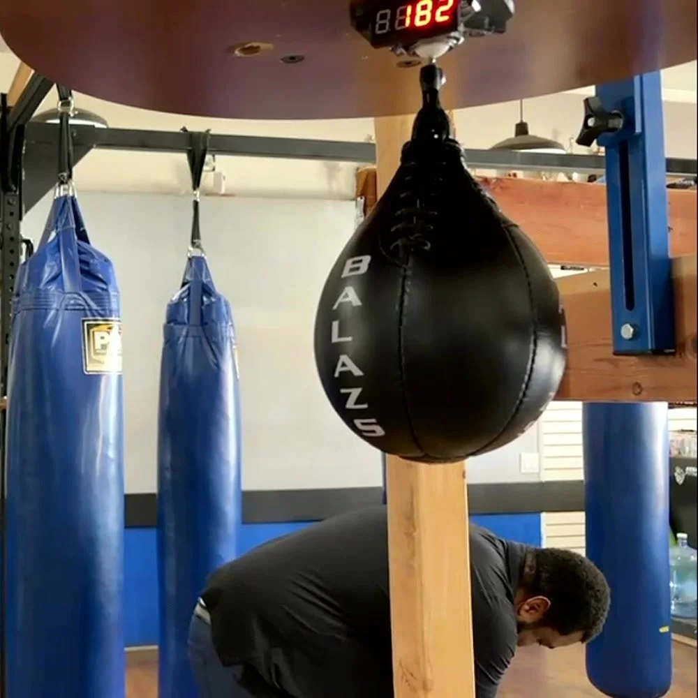 A full speed bag setup: the LED screen under the platform showing 182, the swivel and a black speed bag