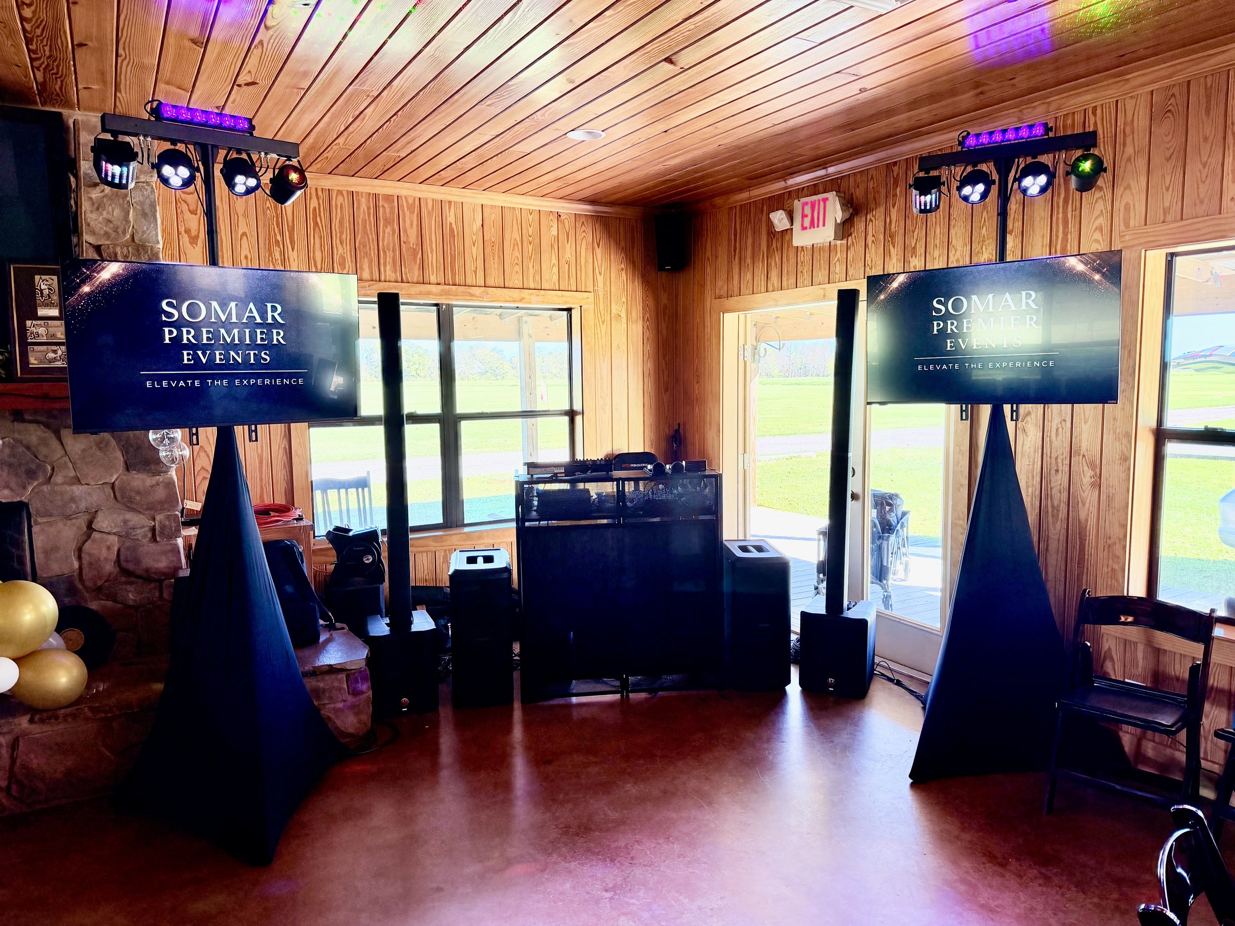 Wedding DJ setup in Fairhope, Alabama featuring dual visual screens, custom lighting, and professional sound by Somar Premier Events. Designed to enhance the guest experience with both audio and visual elements for a seamless wedding reception.