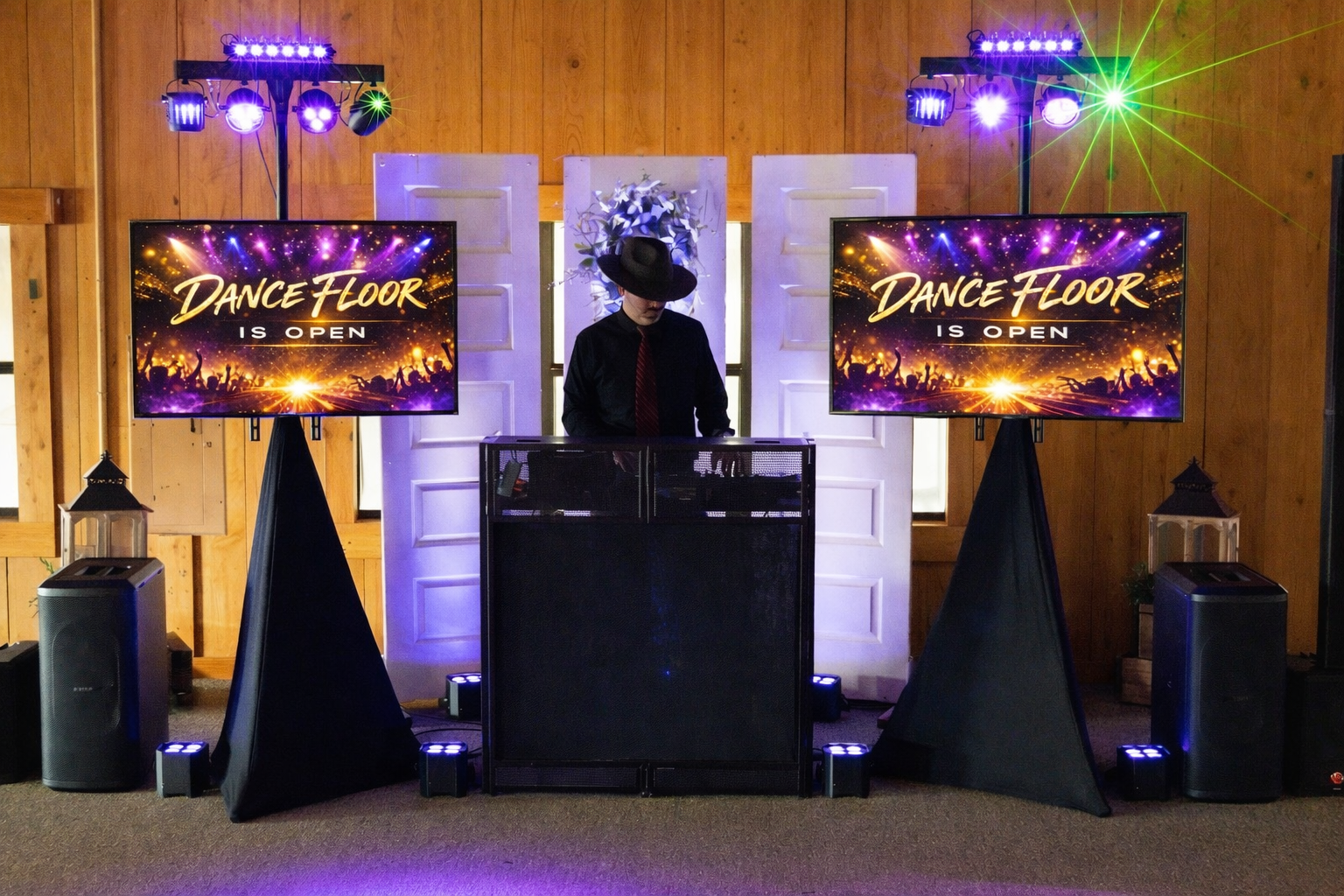 A DJ in black with a black hat is performing on a dance floor, flanked by large screens displaying 'Dance Floor is Open' with colorful concert crowd graphics and lights.