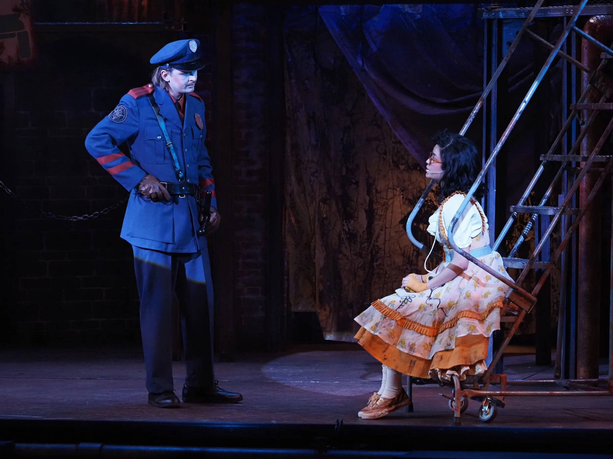 April Plascencia as Little Sally and Luke Stursma as Officer Lockstock in Urinetown at the Nebraska Repertory Theatre (2025)