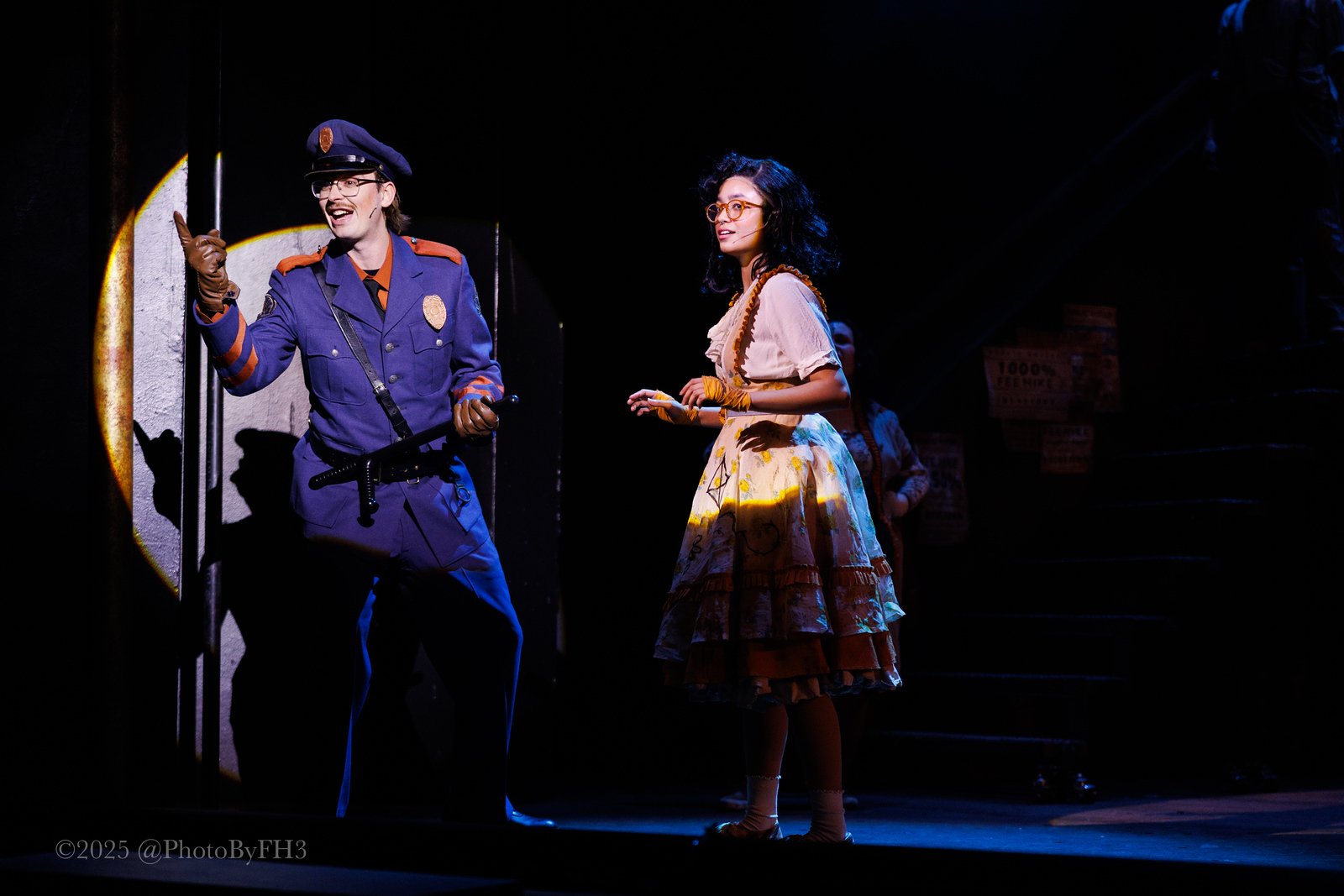 April Plascencia as Little Sally and Luke Stursma as Officer Lockstock in Urinetown at the Nebraska Repertory Theatre (2025)