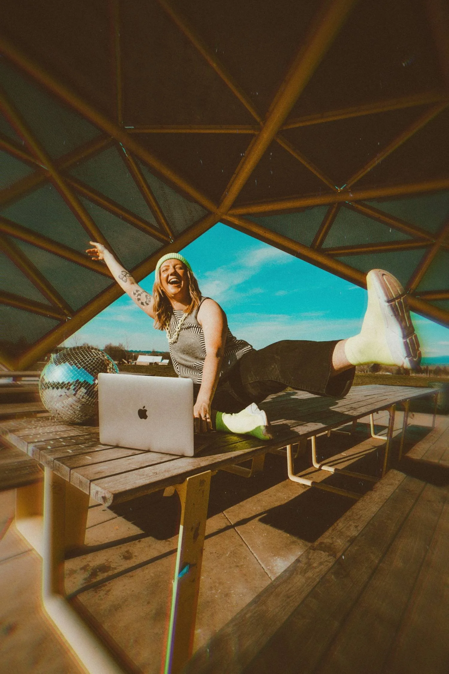 Kayden Doss from Groovetoast web design studios is on her laptop and celebrating a new Squarespace website launch