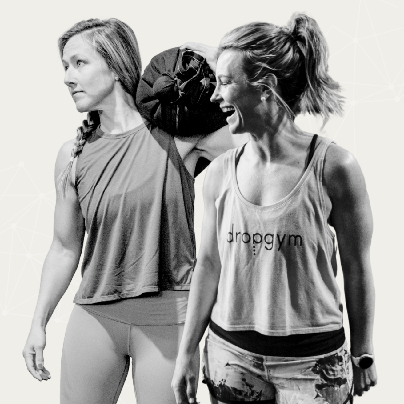 Lu and Shantell founders of Lüsha Method look off to the side, Lu laughing and Shantell holding a sandbag on her shoulder.