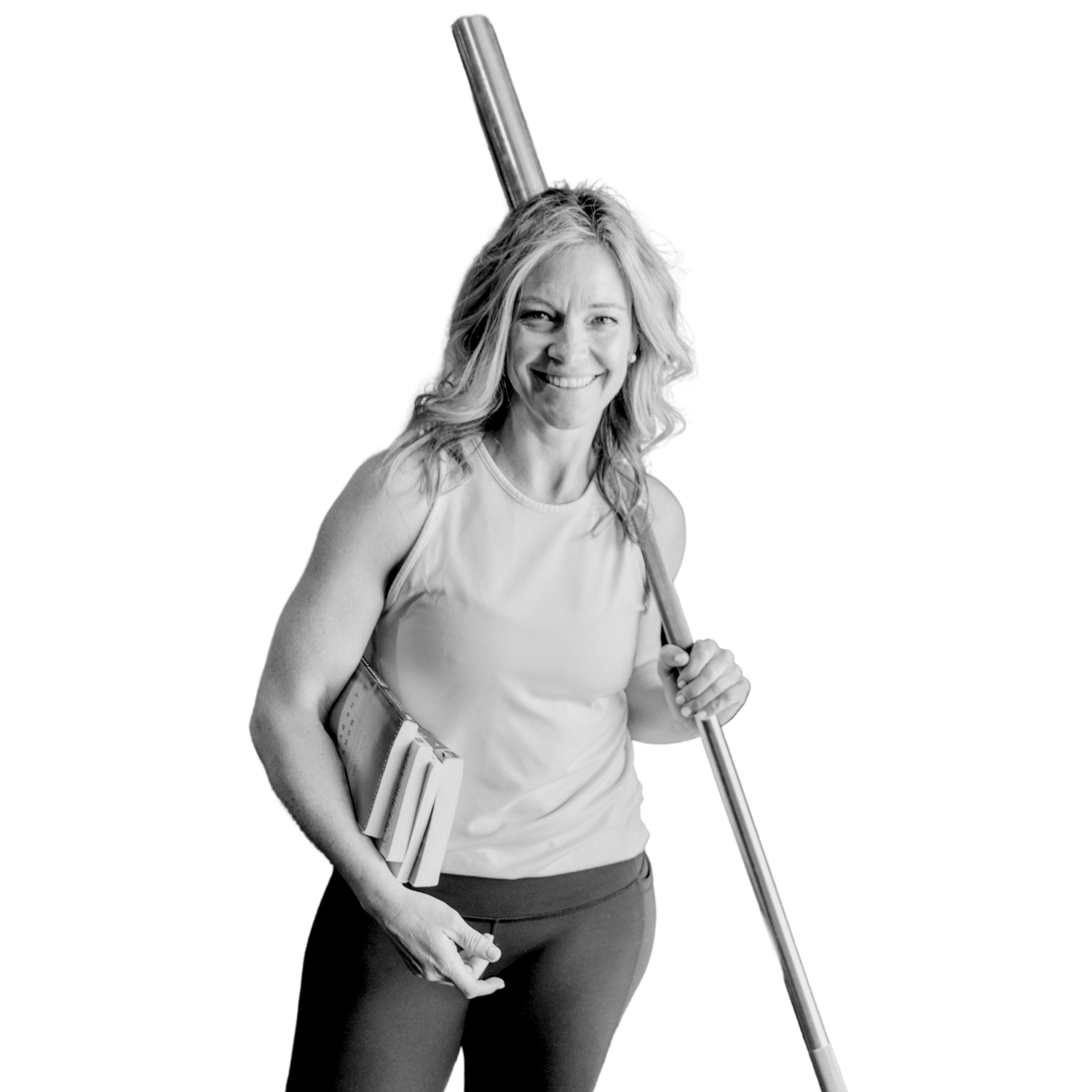 Health and Fitness coach Lu Crenshaw smiling and holding a mobility stick and wearing gym clothes.