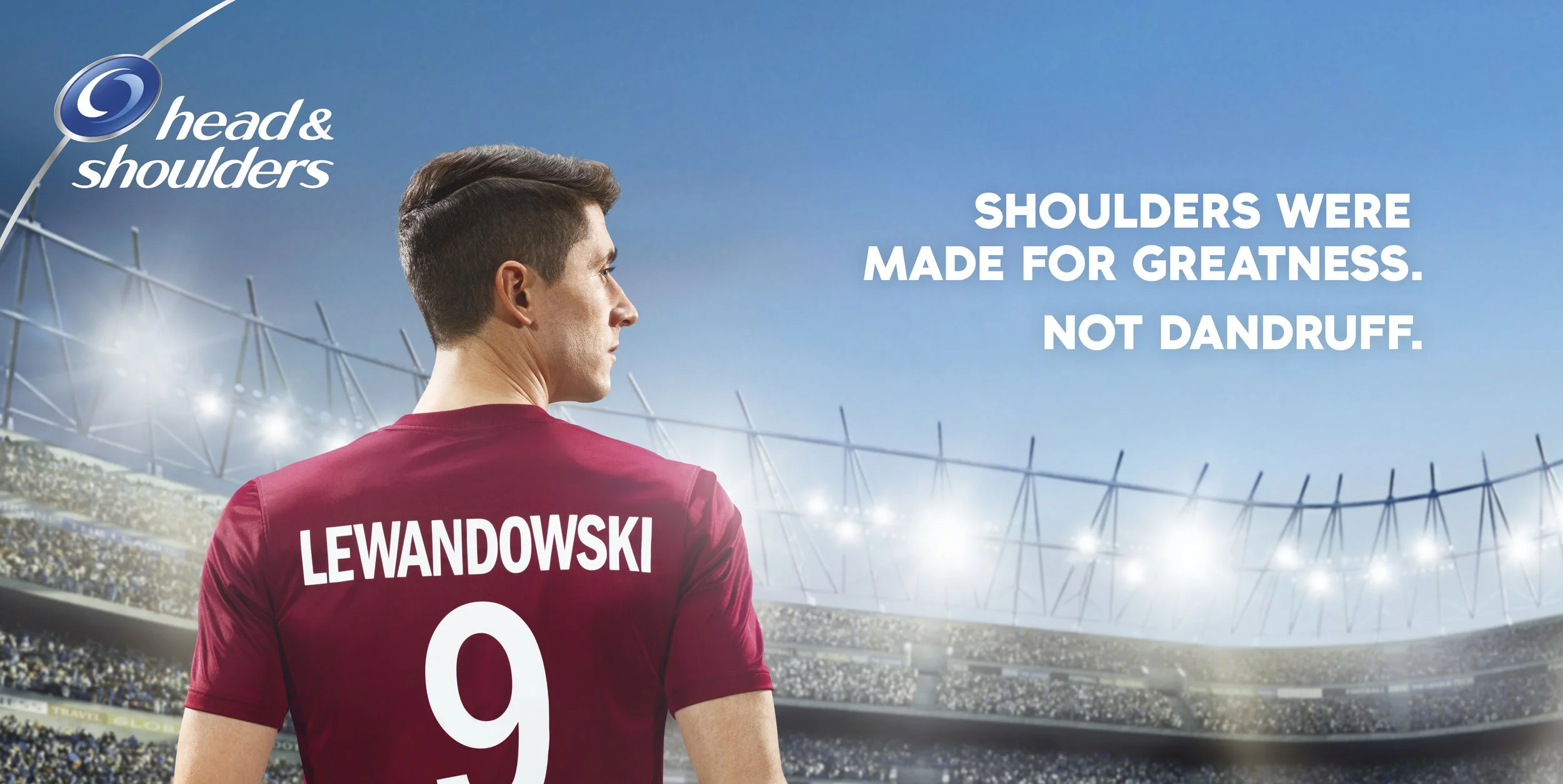 Cristiano Ronaldo wearing a maroon sports jersey with Lewandowski, number 9, written on the back, standing in a stadium filled with fans and bright lights, with the text 'Head & Shoulders. Shoulders were made for greatness. Not dandruff.'