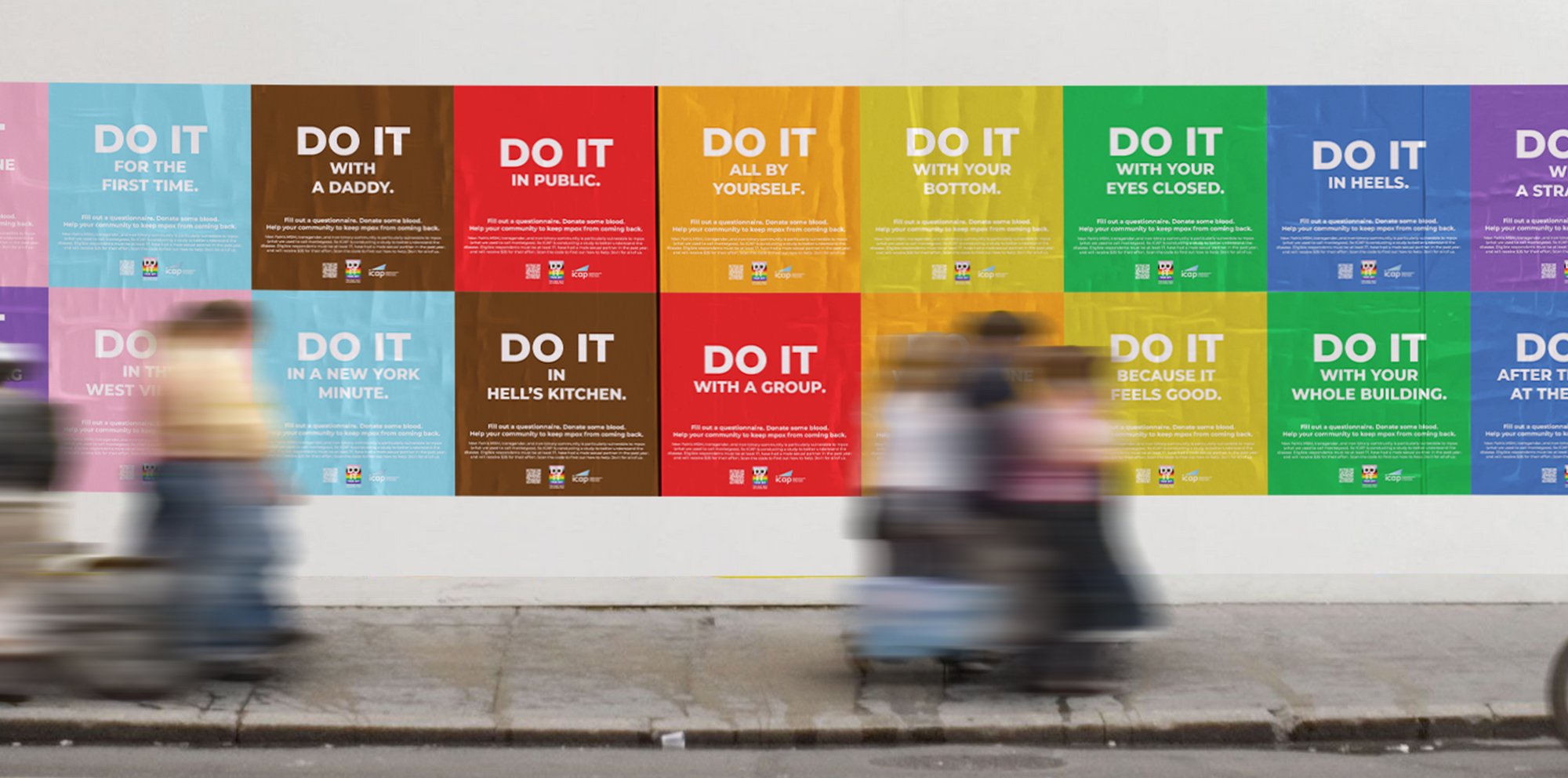 Colorful posters on a wall with messages encouraging doing good deeds, each starting with 'Do It' and varying in phrases like for the first time, with a daddy, in public, all by yourself, with your bottom, with your eyes closed, in heels, in a new York minute, in hell's kitchen, with a group, because it feels good, with your whole building, after the tea at the end.