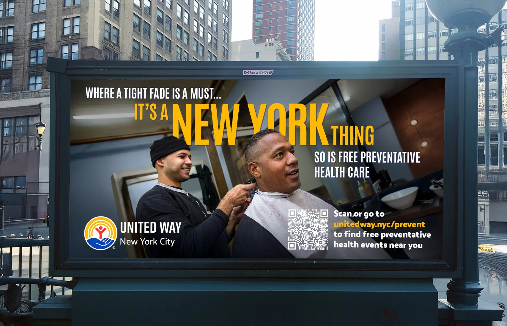 Billboard in New York City promoting free preventive health care through United Way, featuring a man getting a haircut in a barbershop.