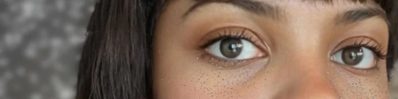 Glitter tear makeup close-up embodying rebellion against minimalism, from runway to queer protest.