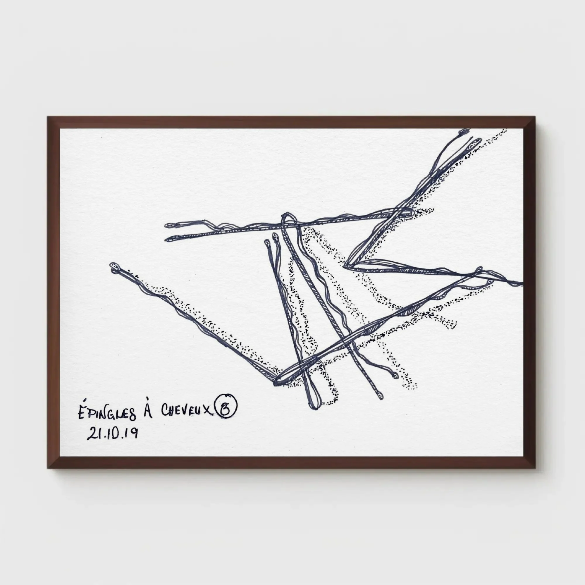 Close-up of framed ink drawing "Épingles à Cheveux No. 3" by Glissandre Bryant, mounted on a plain wall