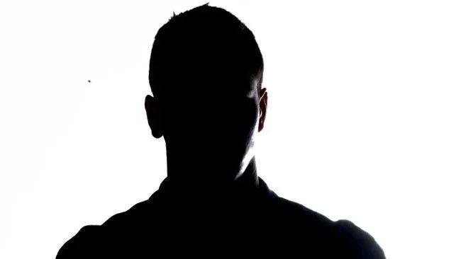 Silhouette of a person against a white background.