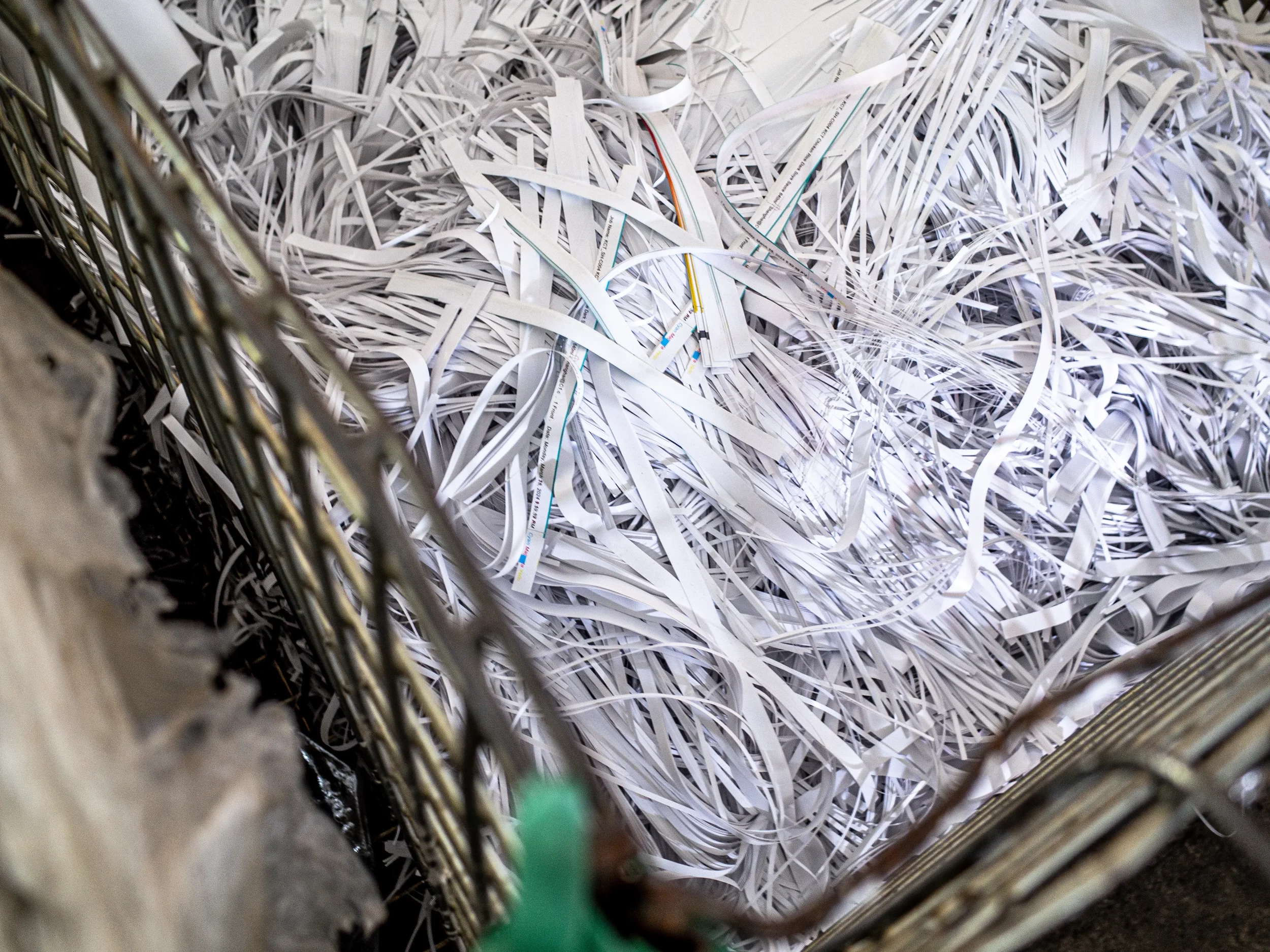 Shredded paper materials representing recycling processes, waste reduction, and environmentally responsible production practices.​