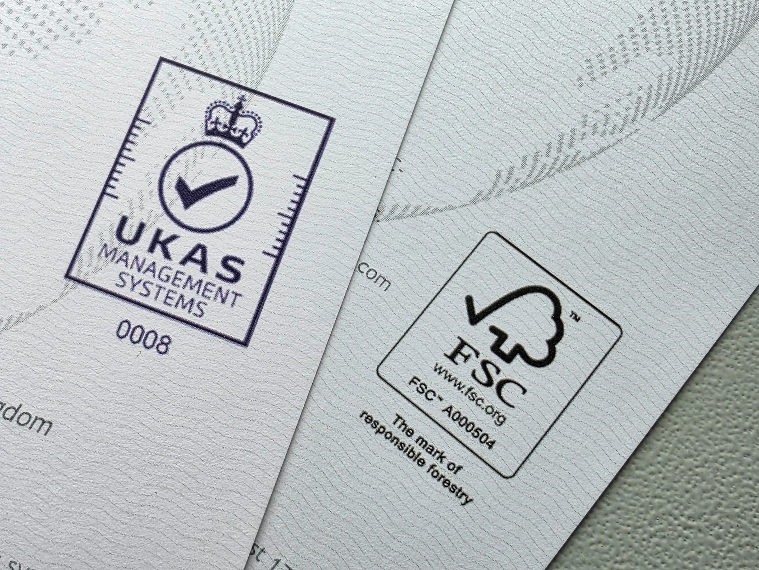 Printed materials with ISO 9001 and FSC certification marks, representing responsible sourcing and sustainable packaging production.​