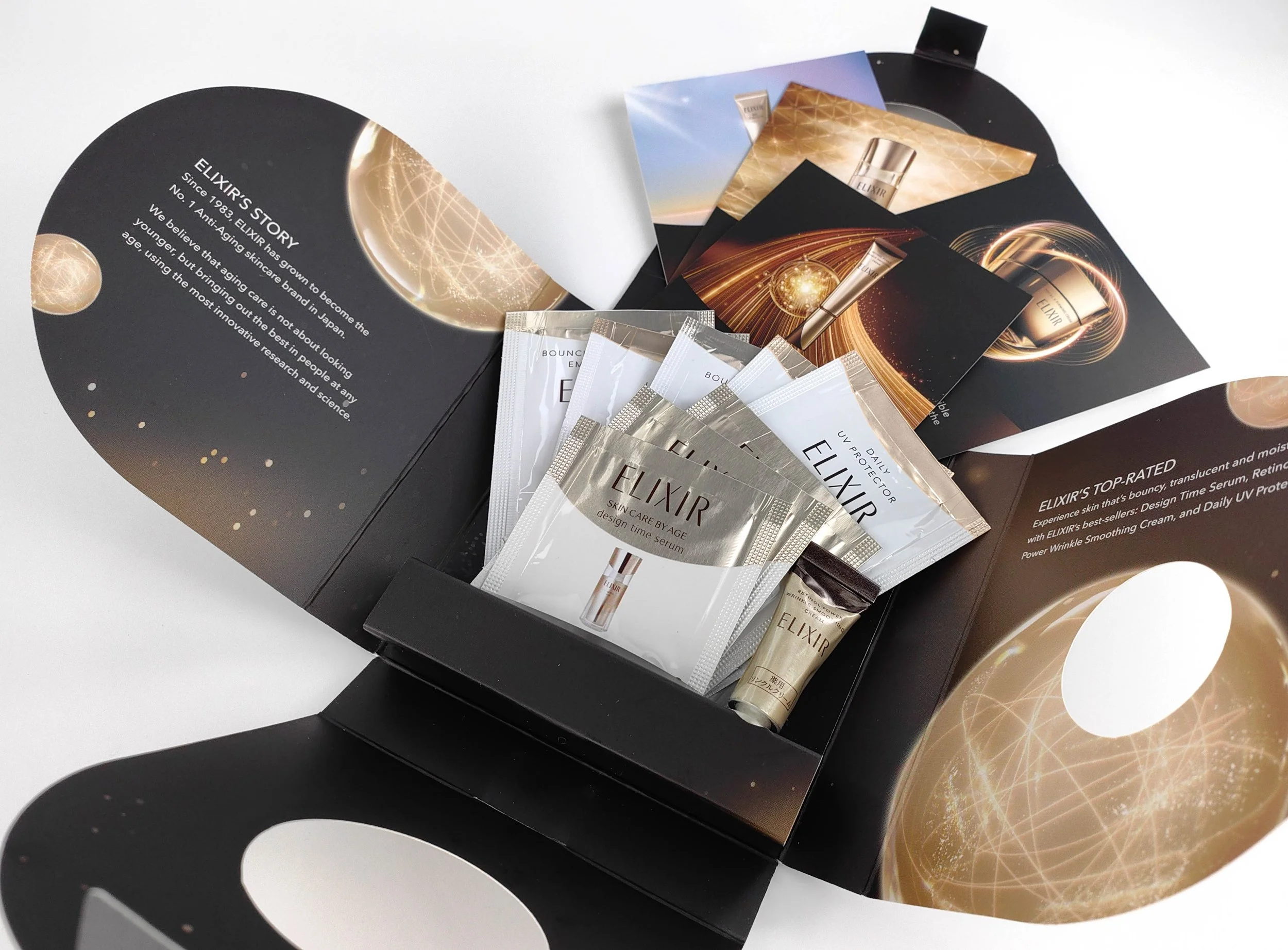 Elixir sample kit with organised skincare sachets inside a structured box, showing compartment layout for product display and distribution.​