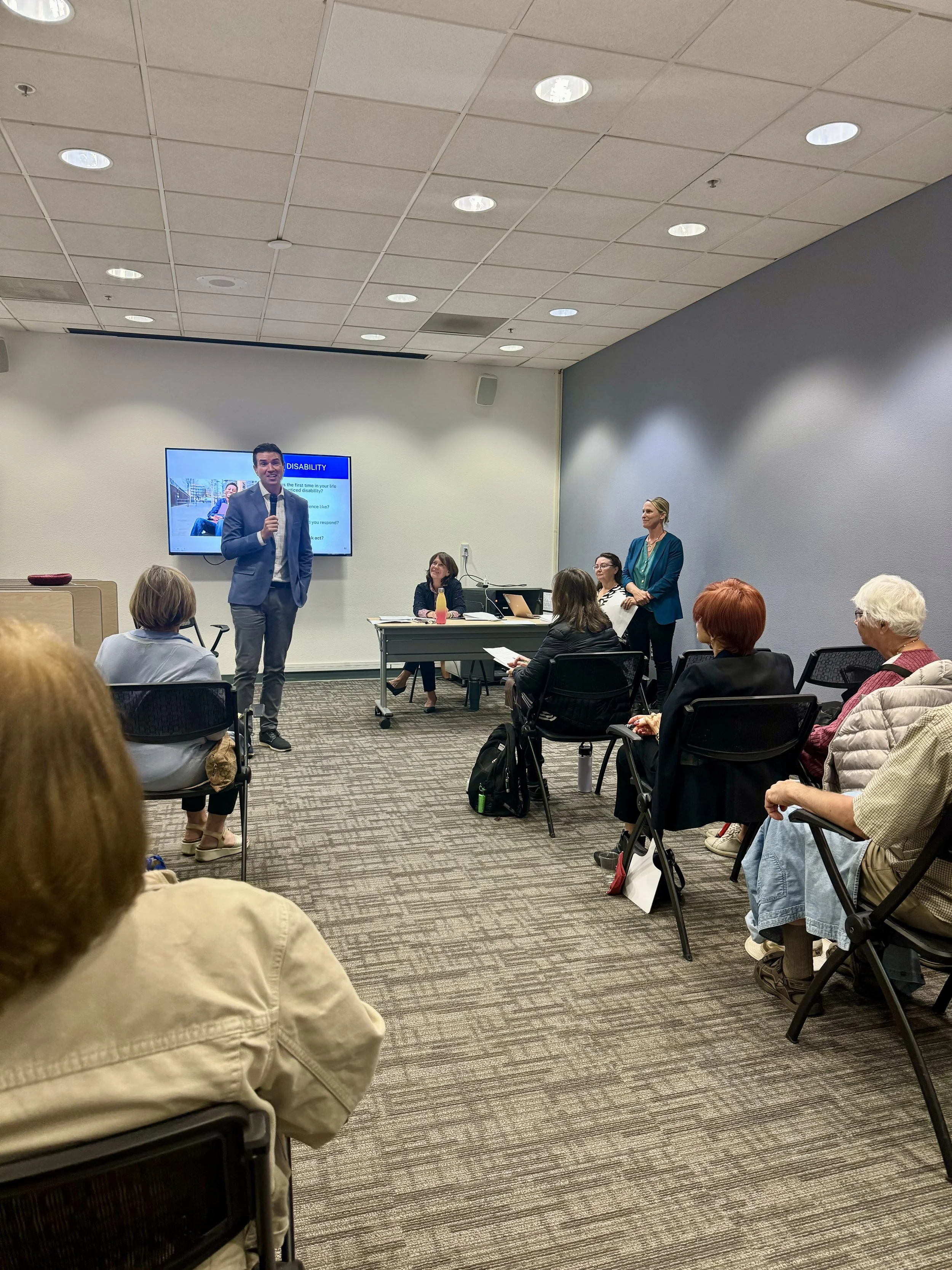 Conference room with people listening to a speaker.
