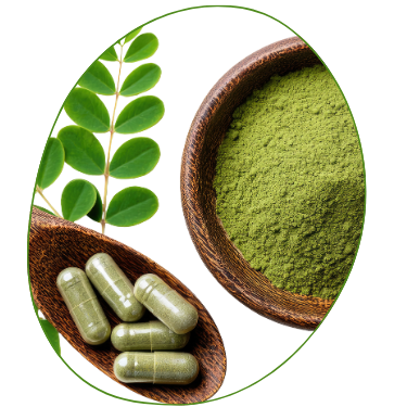 Herbal supplement capsules and green powder with fresh leaves