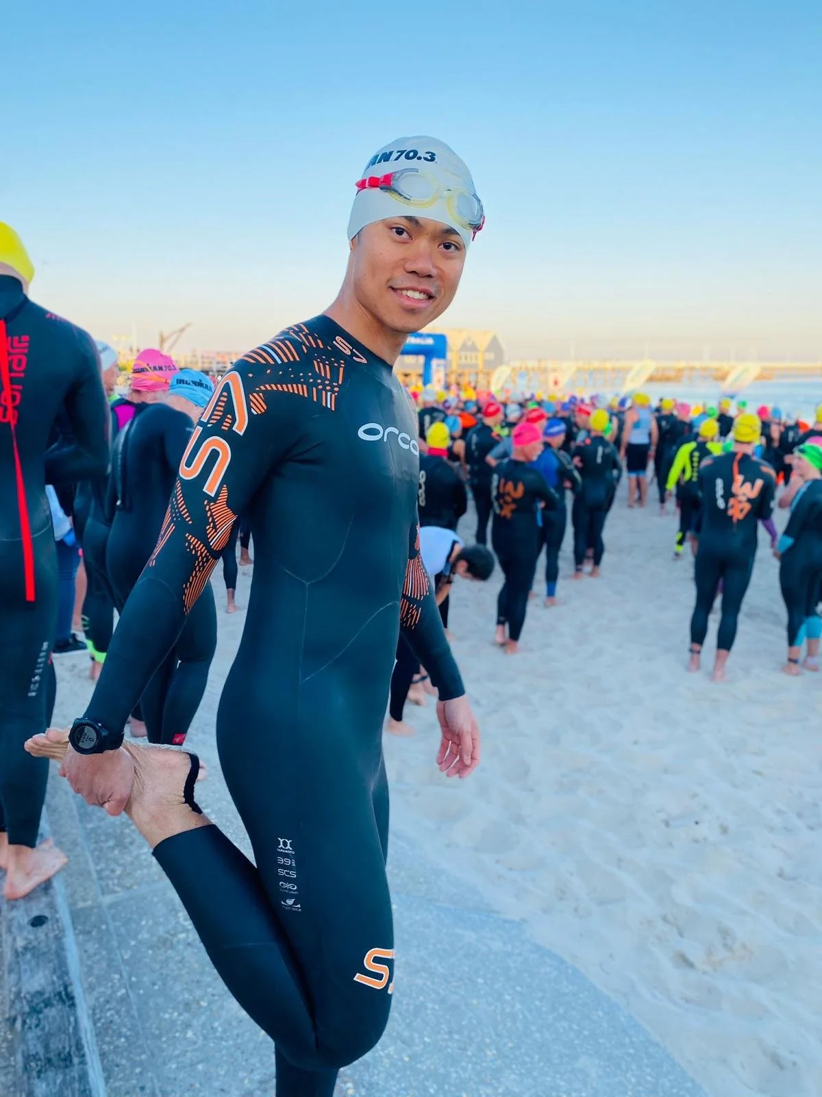 Pharmacist Sim Lee in a wetsuit at a triathlon start line