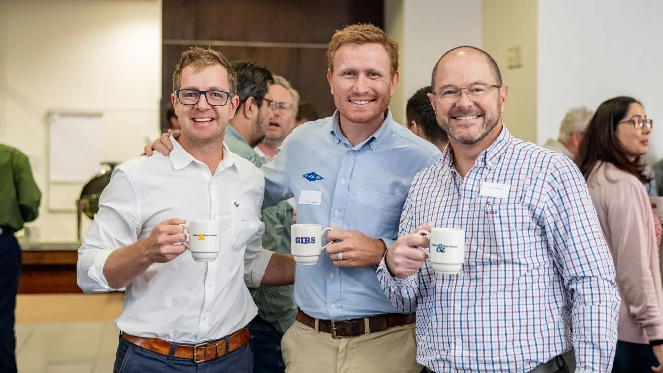 Three business professionals standing together at the Scale Up Partners conference in Johannesburg, April 2025 