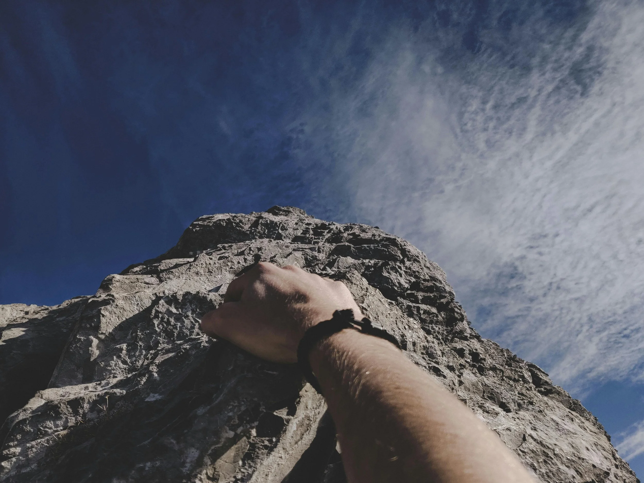 Close-up of a climber gripping rock symbolising resilience, determination, and overcoming business challenges with Scale Up Partners.