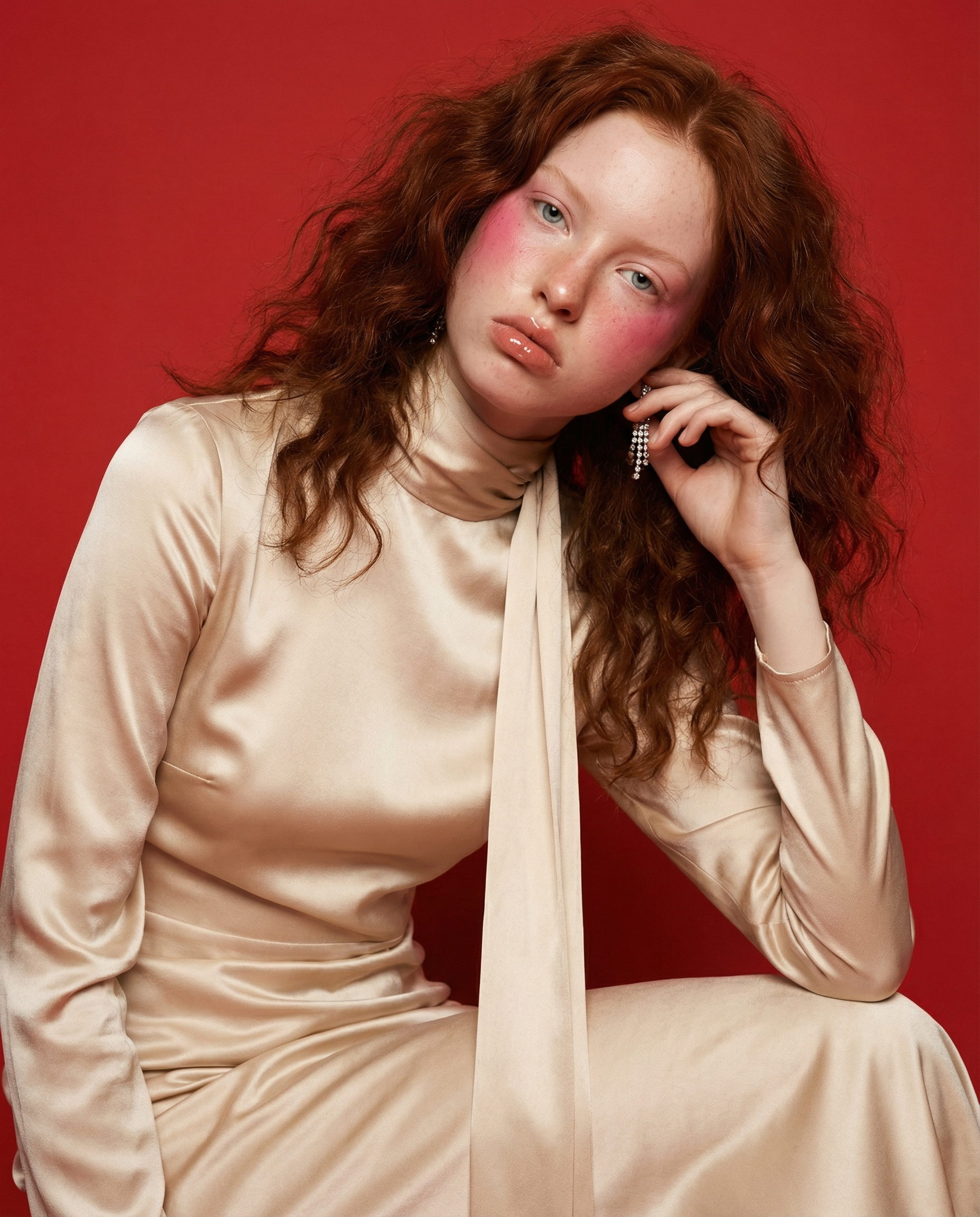 girl_in_champagne_dress_against_red_background.png