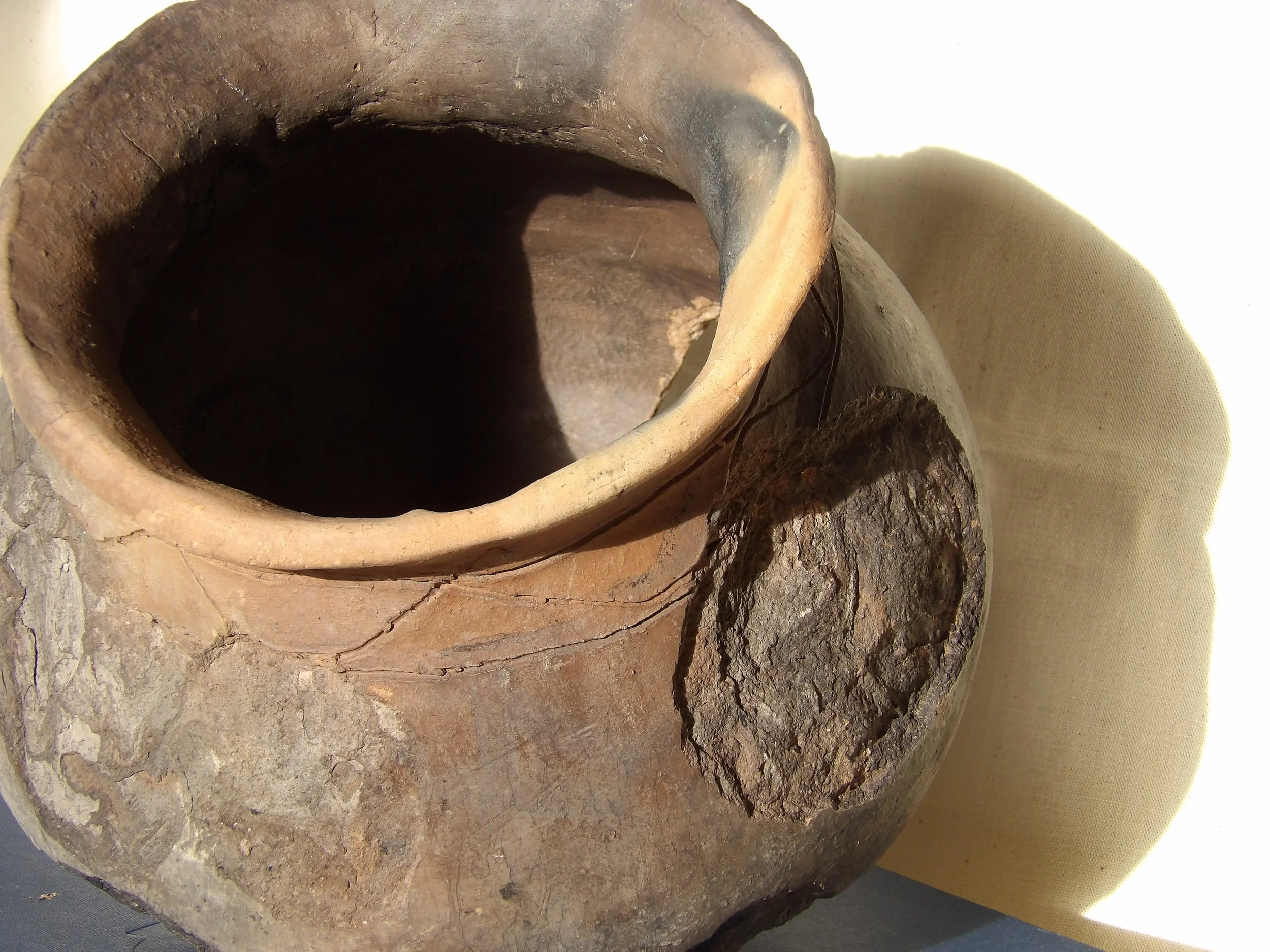 Constructed through hand-building and low-temperature firing, the pot reflects historical techniques associated with enslaved African and Indigenous ceramic practices.