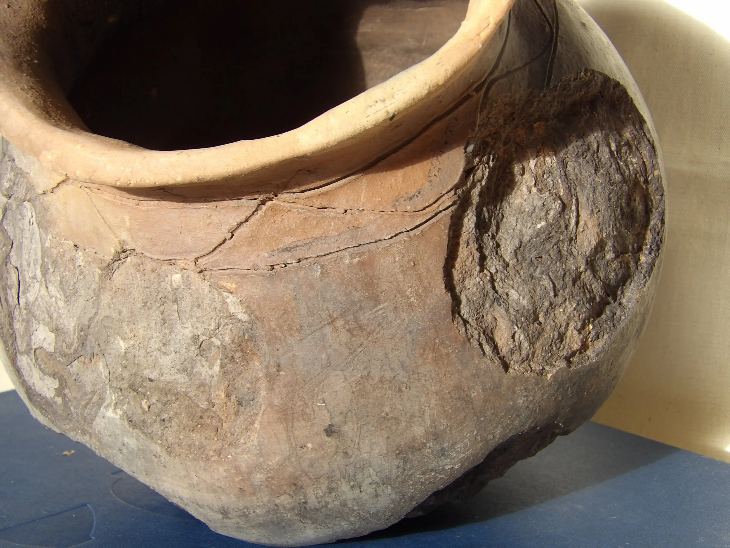 Hand-built earthenware vessel replicating an early Black Atlantic colonoware form. Made from wild clay and low-fired, the pot features a rounded body, restricted neck, and subtle surface variation resulting from coil construction and burnishing.