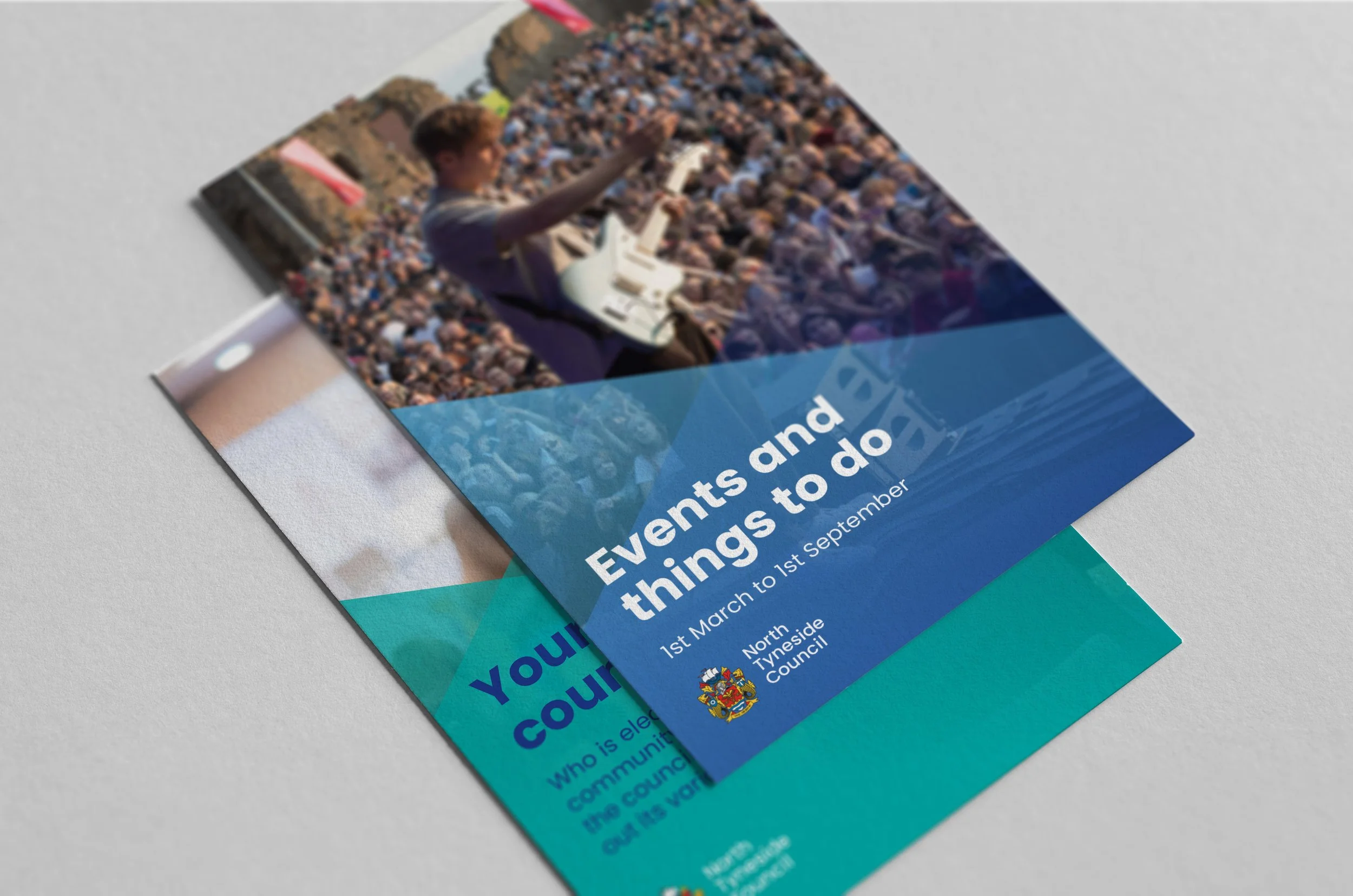 A photo of two colourful leaflet covers, advertising things to do in North Tyneside