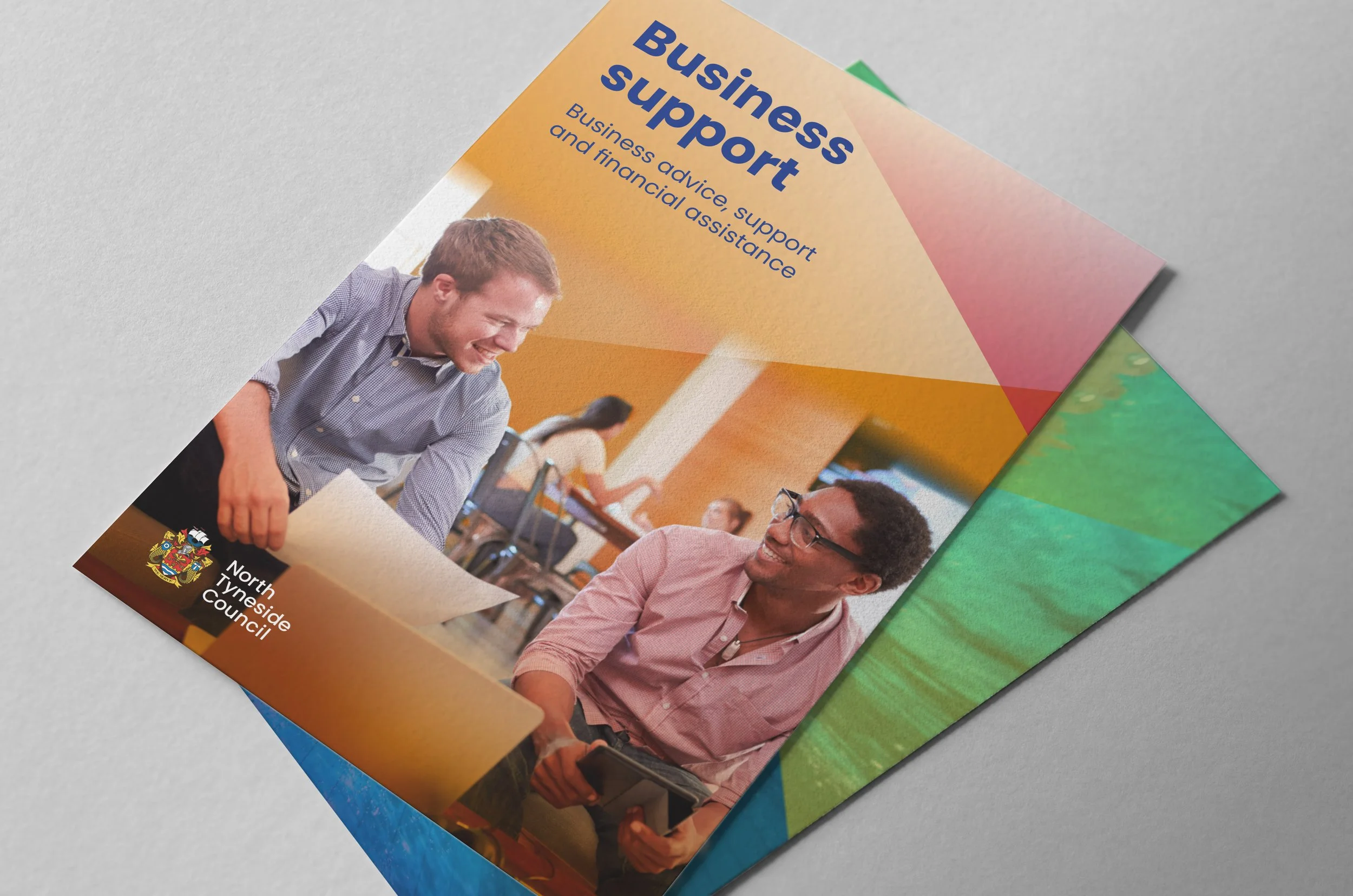 A photo of two colourful leaflet covers, advertising Business support in North Tyneside