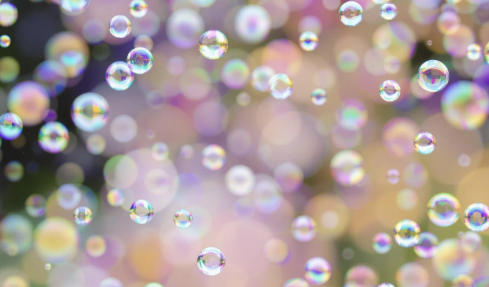 Colorful bubbles floating in the air against a blurred background.