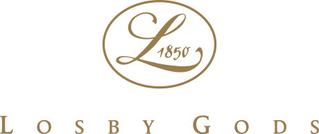 Logo med teksten '1850' og 'Losby Gods' i gullfarge på svart bakgrunn