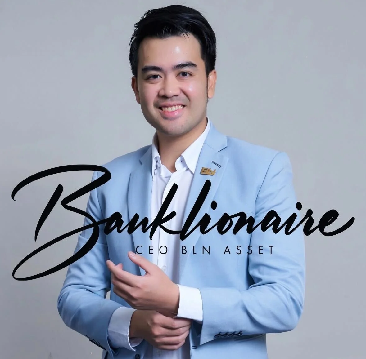 A young man in a light blue suit and white shirt, smiling with one hand on his chest, standing against a plain gray background, with the words "Bankioneer CEO BLN ASSET" written across the image.