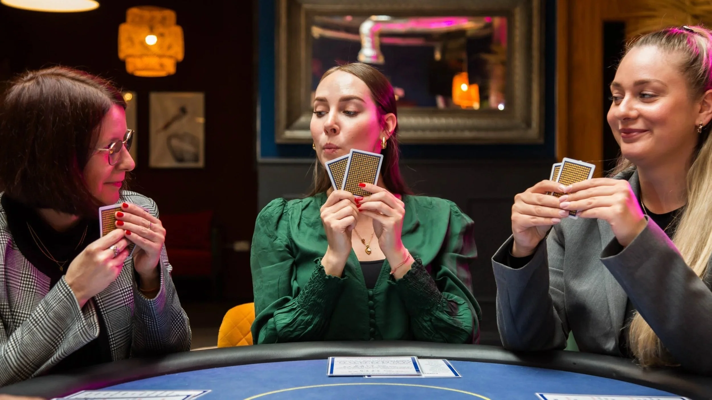 Players holding their cards at an Aces High workshop