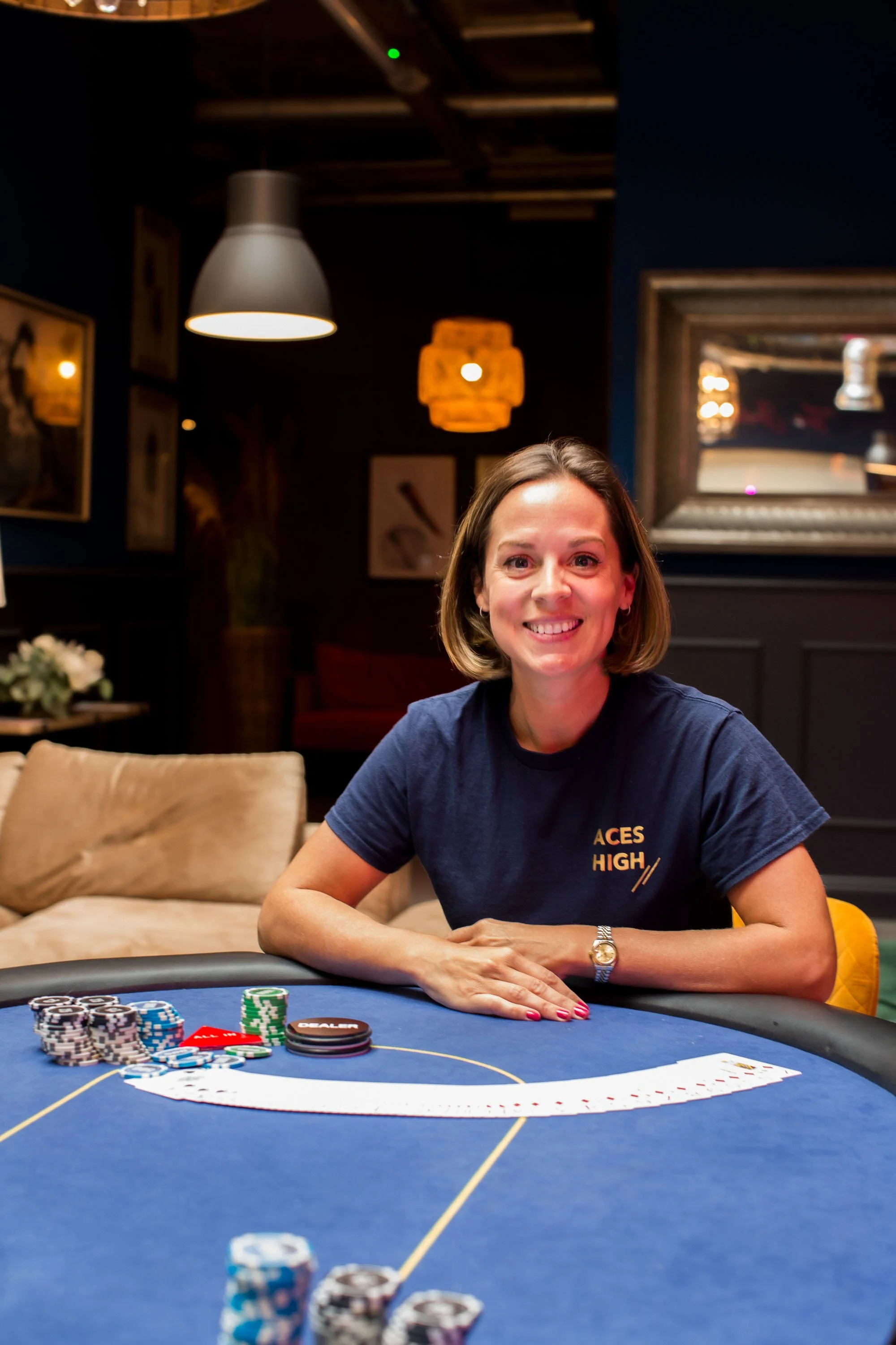 Founder of Aces High - Jo Living - at a Texas Hold'em poker table delivering corporate team-building workshop and skills training for team dynamics