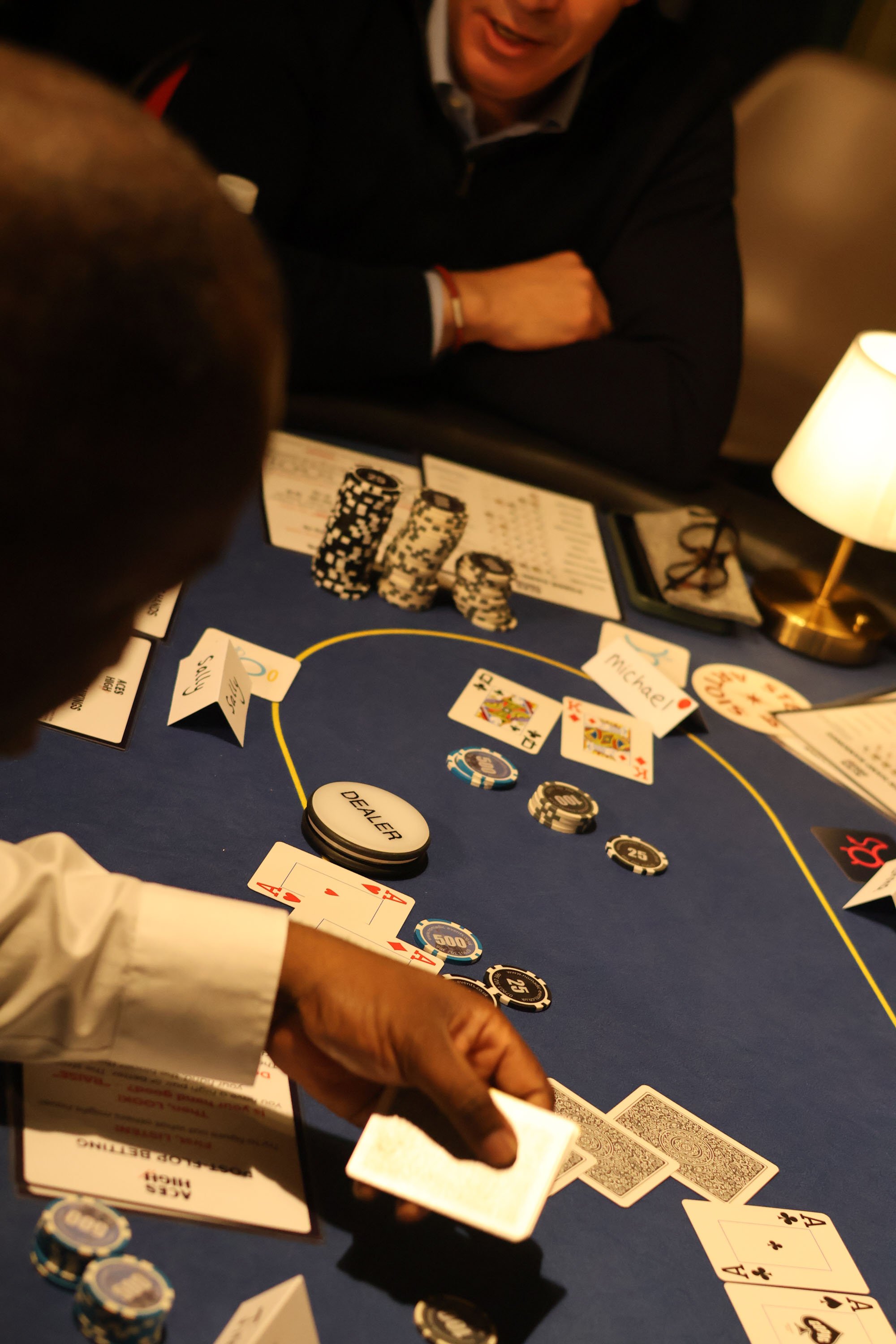 People playing poker at a casino table with chips and playing cards for a gamified corporate workshop and negotiation training in London