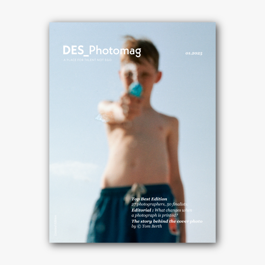 Magazine cover featuring a blurred image of a boy pointing a water gun at the camera, under the title 'DES_Photomag' with text about photography editions and an editorial.