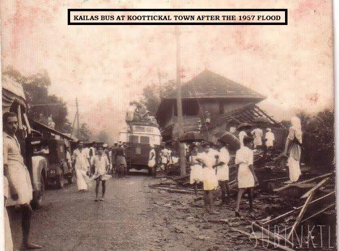 Historical black and white photo of a bus at Koottickal town after the 1957 flood, with people standing around and damaged buildings in the background.