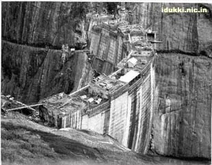A large sinkhole with collapsed buildings and structures, revealing the earth beneath.