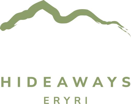 Hafan Hideaways logo with white text and green mountain motif in green brushstroke graphic.