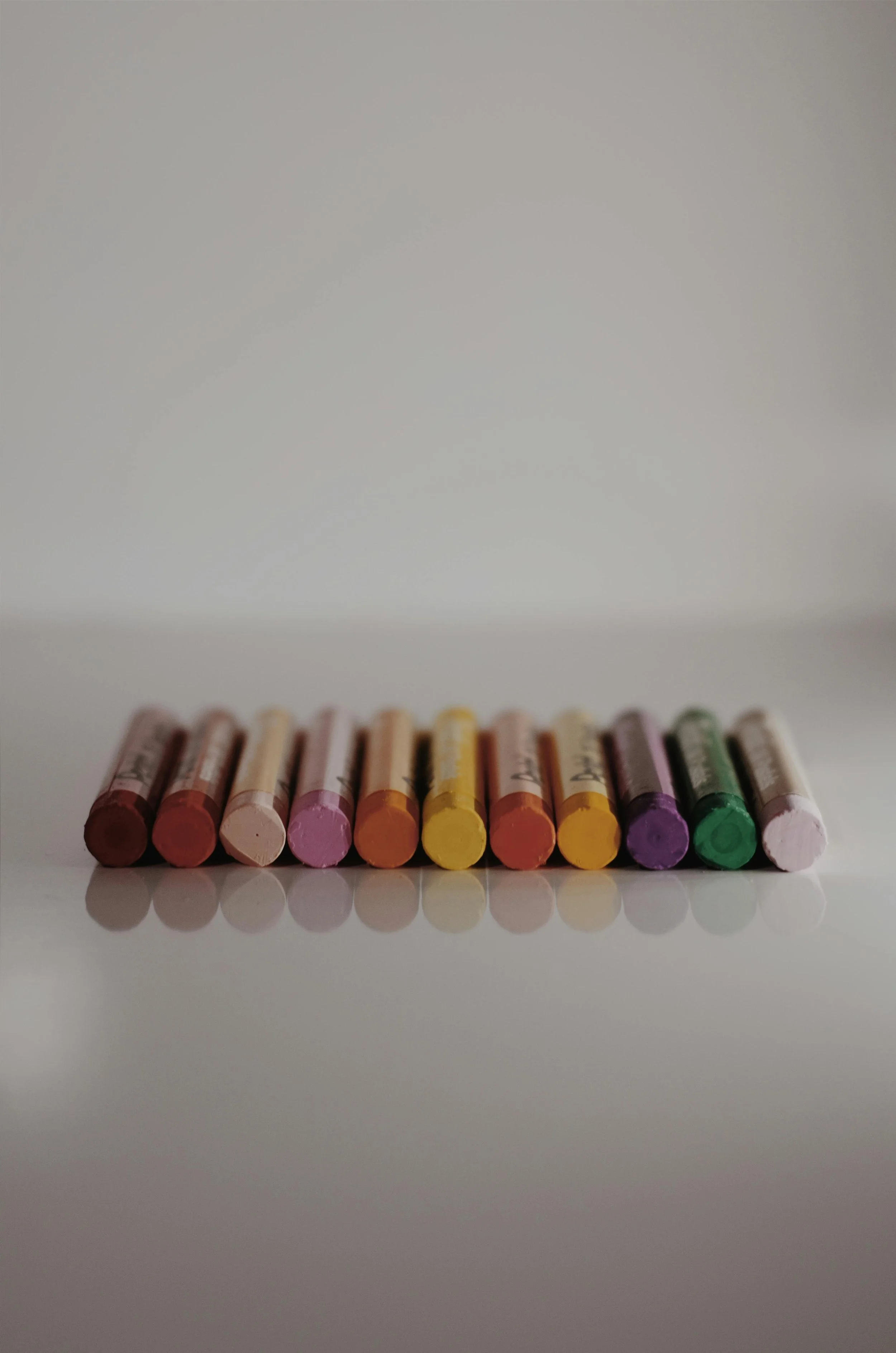 A row of colorful chalks representing child therapy for anxiety and emotional regulation in Massachusetts