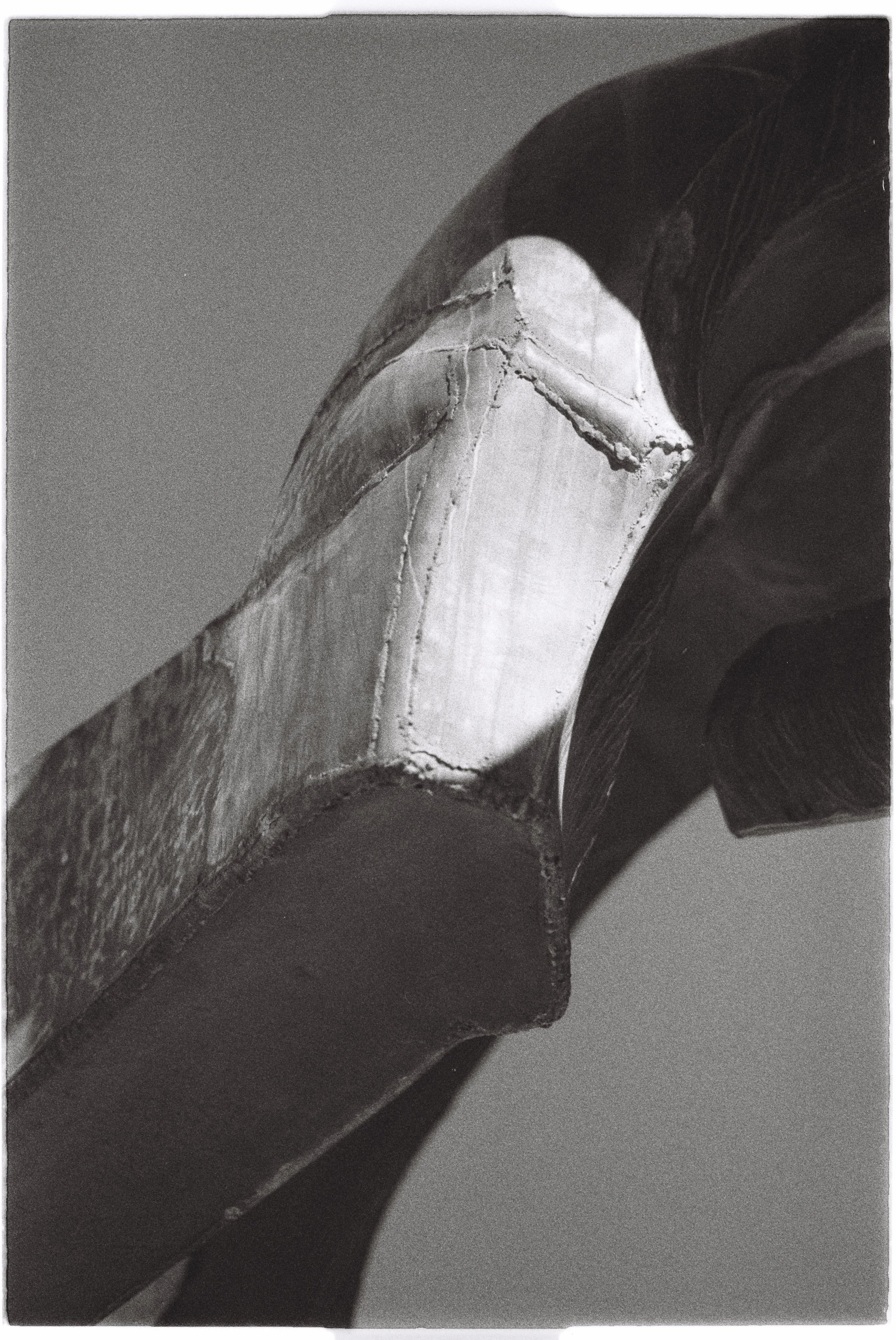 Close-up of abstract architectural structures with sharp angles and contrasting light and shadow.