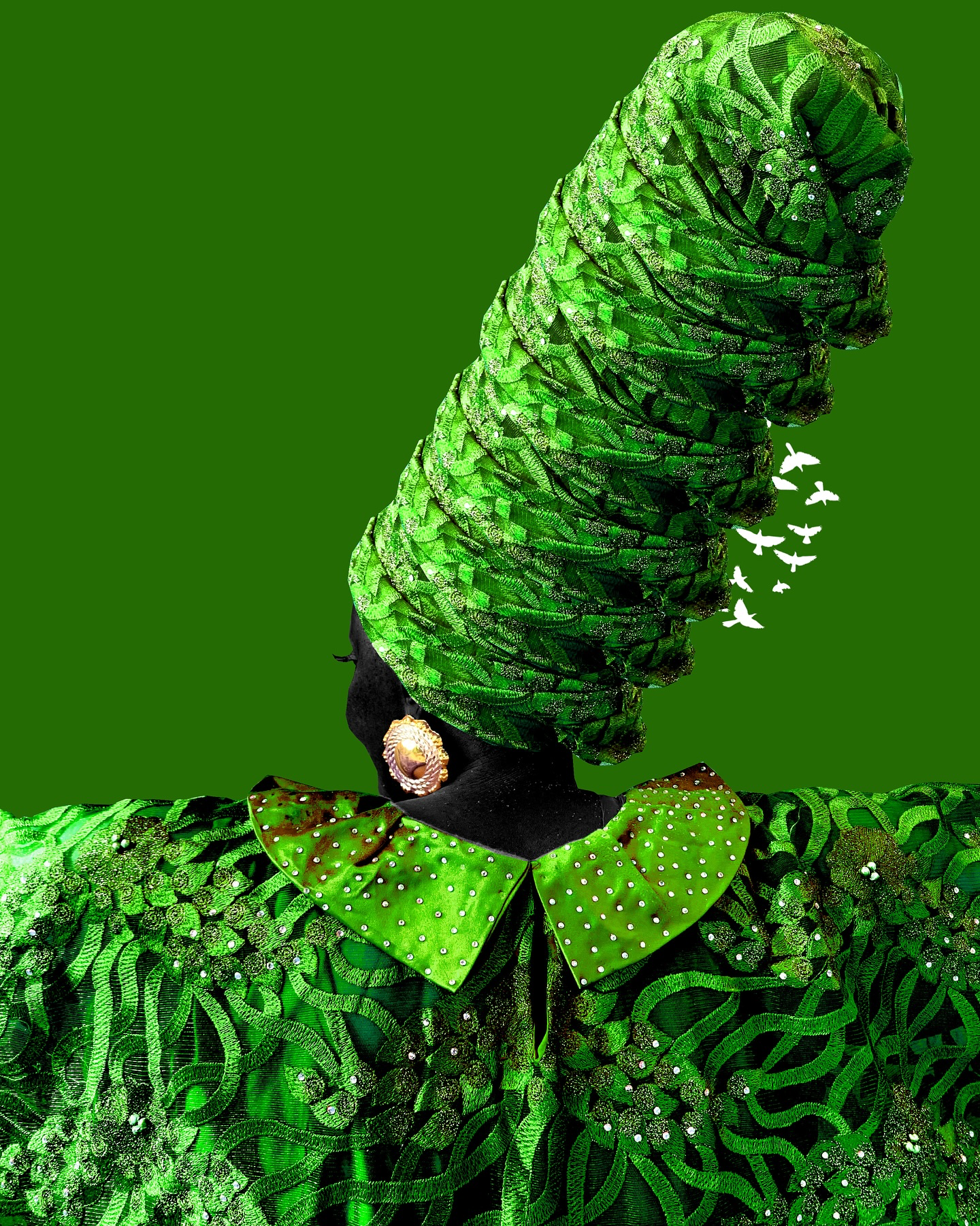 A person dressed in a green, leafy patterned outfit with fabric styled like a headdress and a collar, with large earrings and a black face.