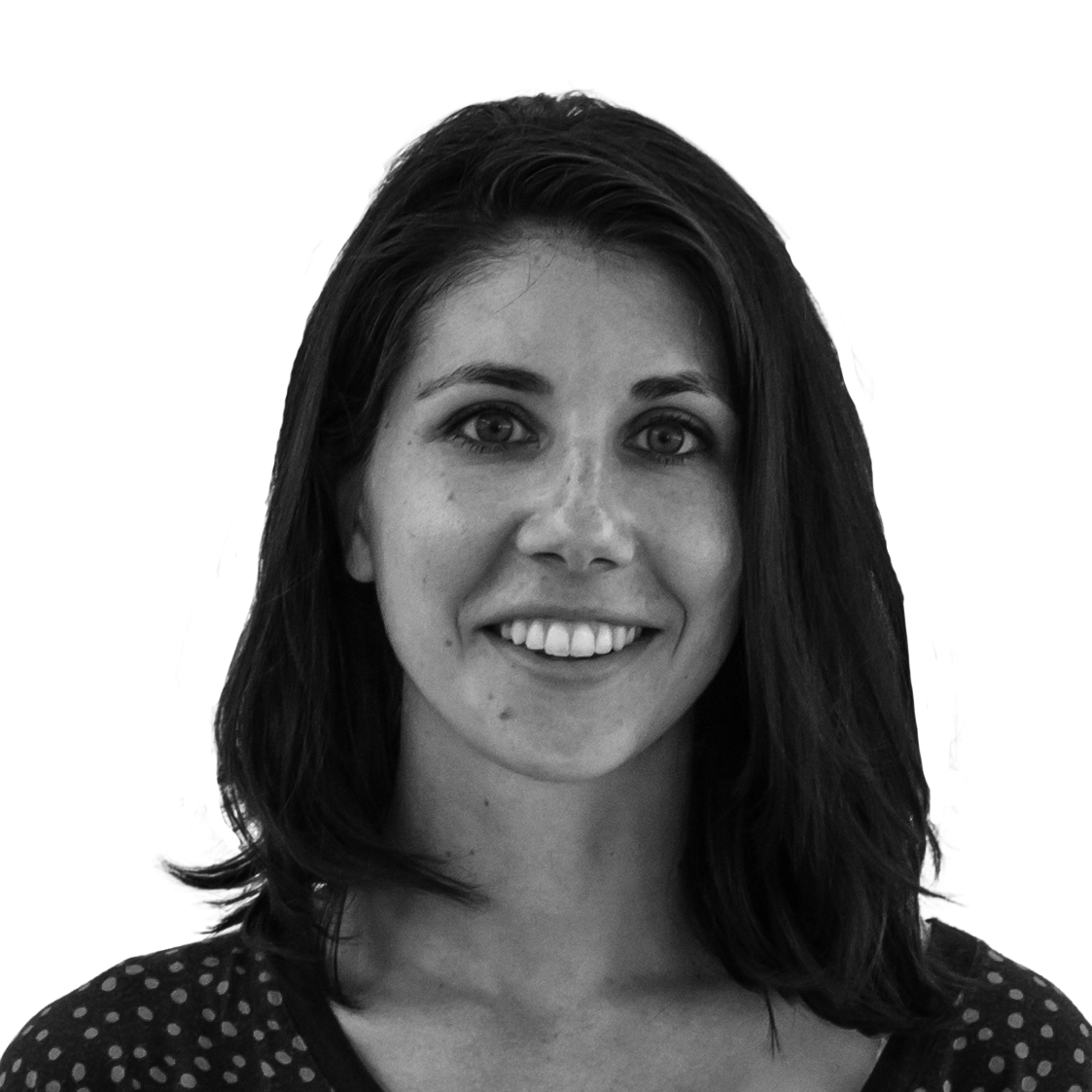 Black and white portrait of a young woman with shoulder-length dark hair, smiling, wearing a dotted top, against a plain light background.