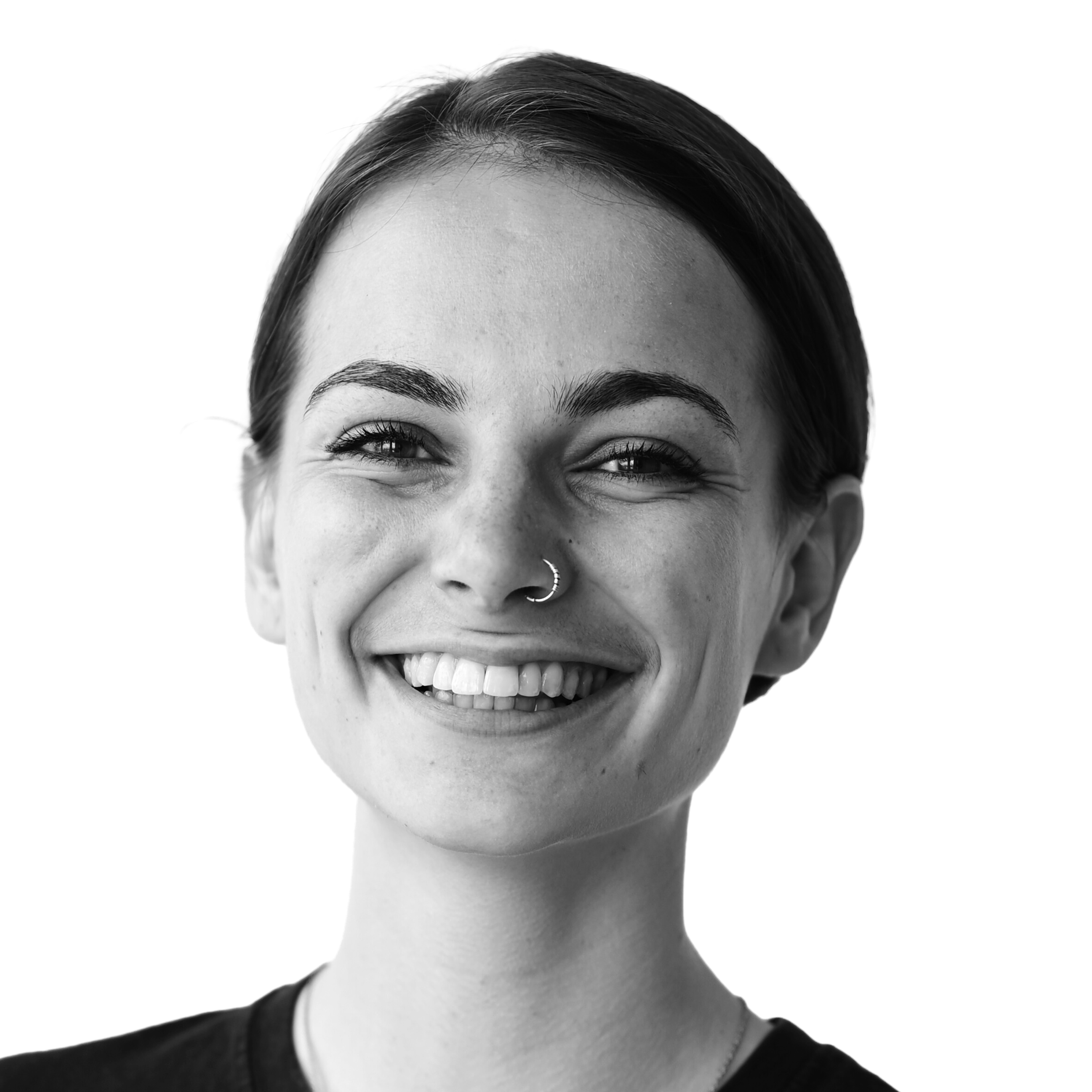 Black and white portrait of a smiling woman with short dark hair and a nose ring.