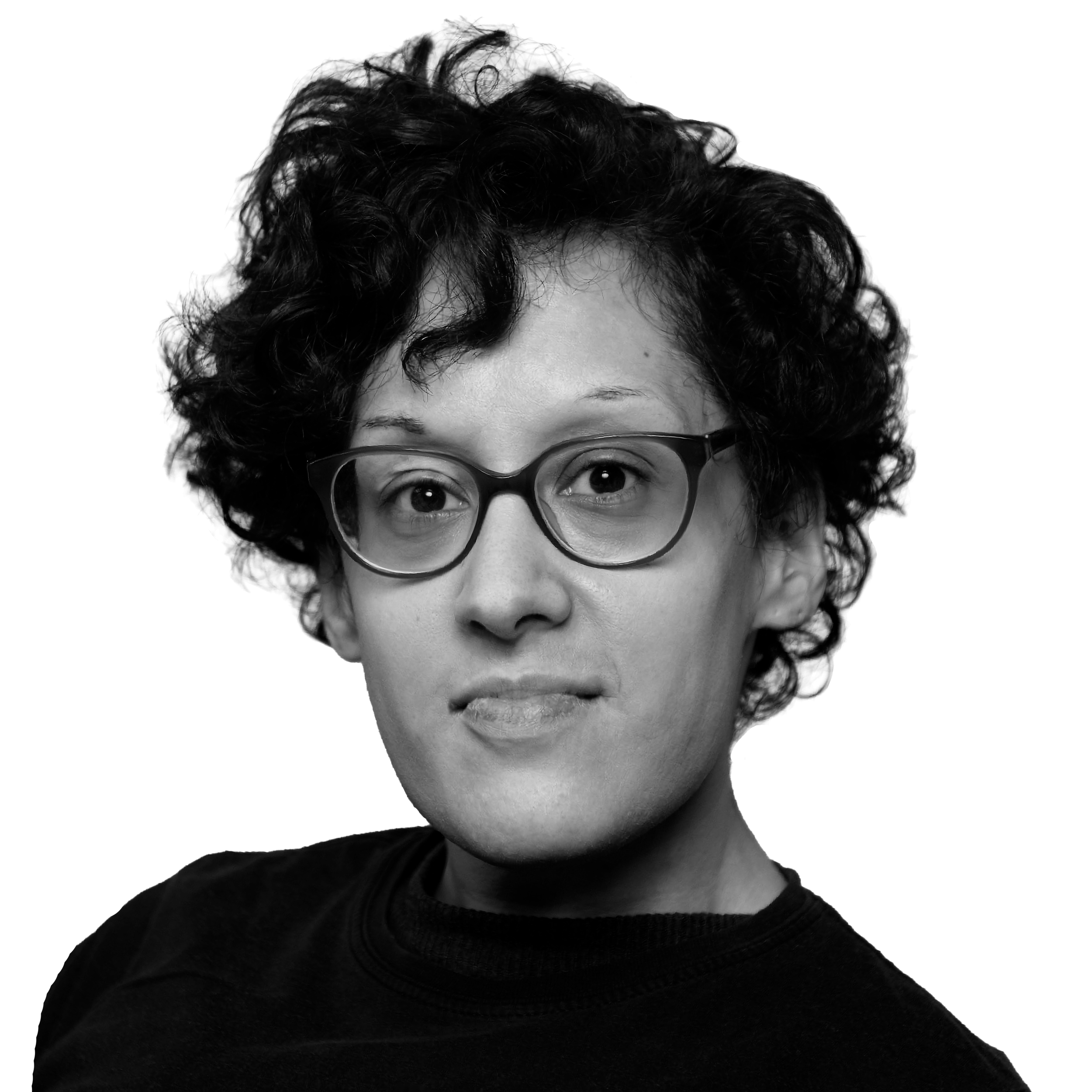 Black and white portrait of a woman with glasses and curly hair, looking into the camera.